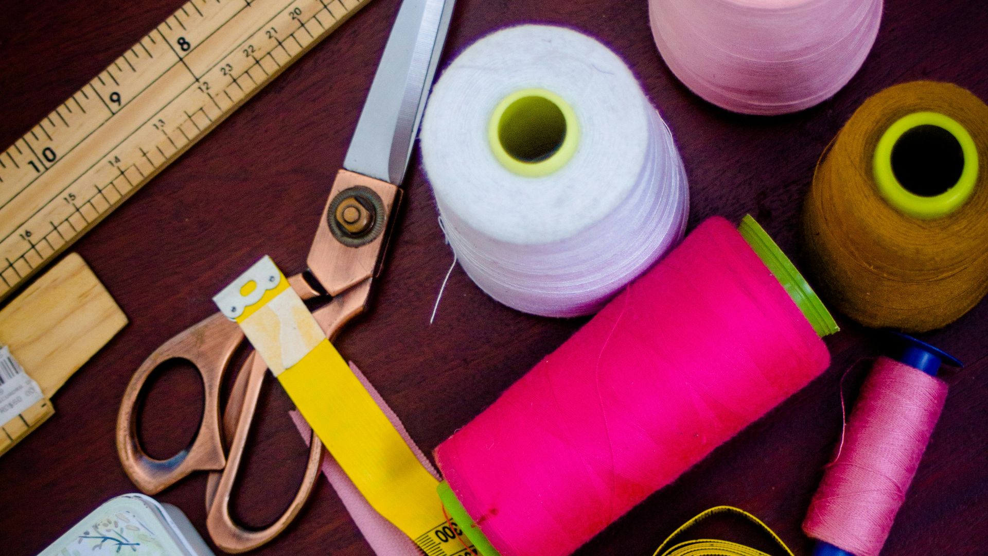 threads with spools beside scissors