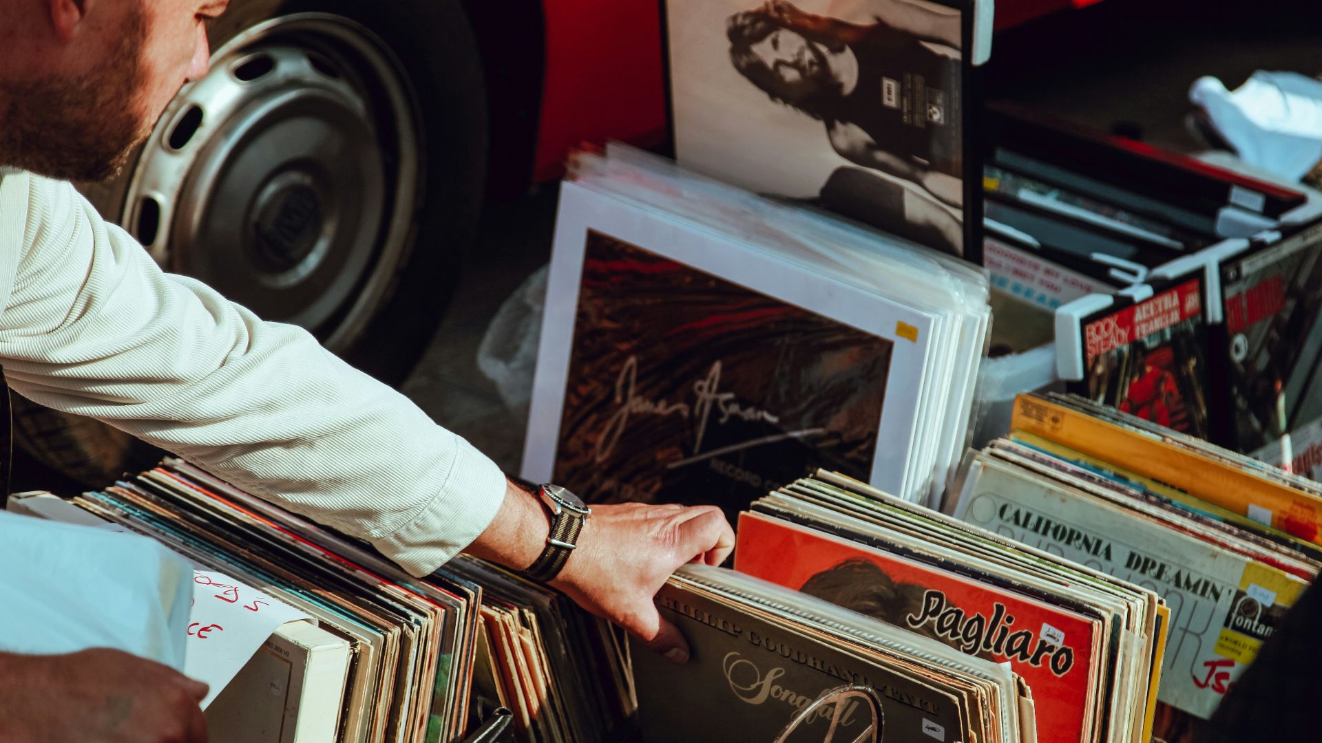 person holding vinyl records