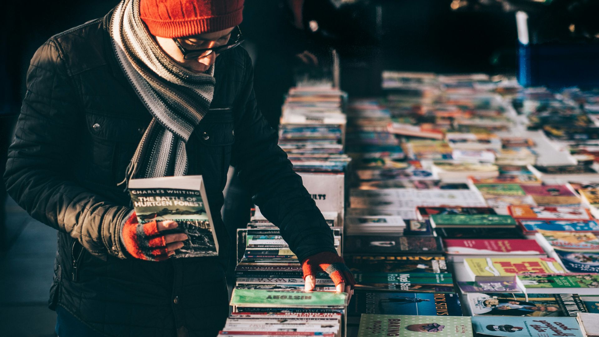 man picking up book ob book sale