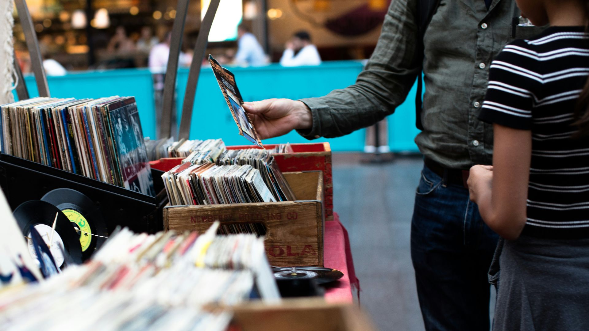 men standing in front of vinyl record sale