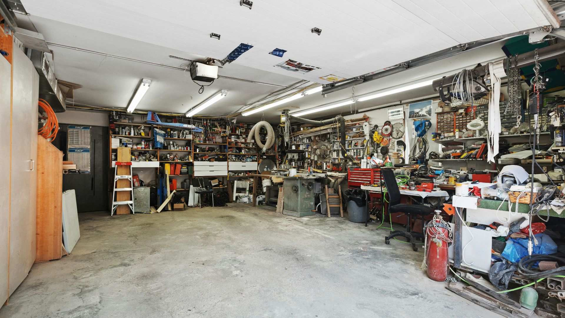 a garage filled with lots of clutter and tools