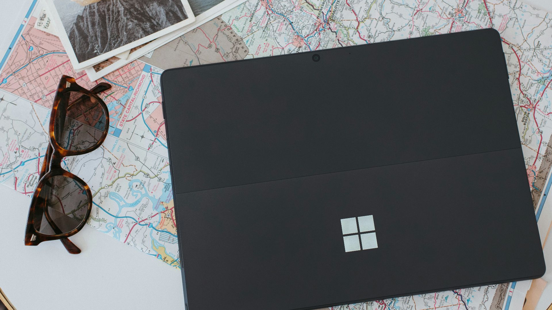 a laptop computer sitting on top of a white table