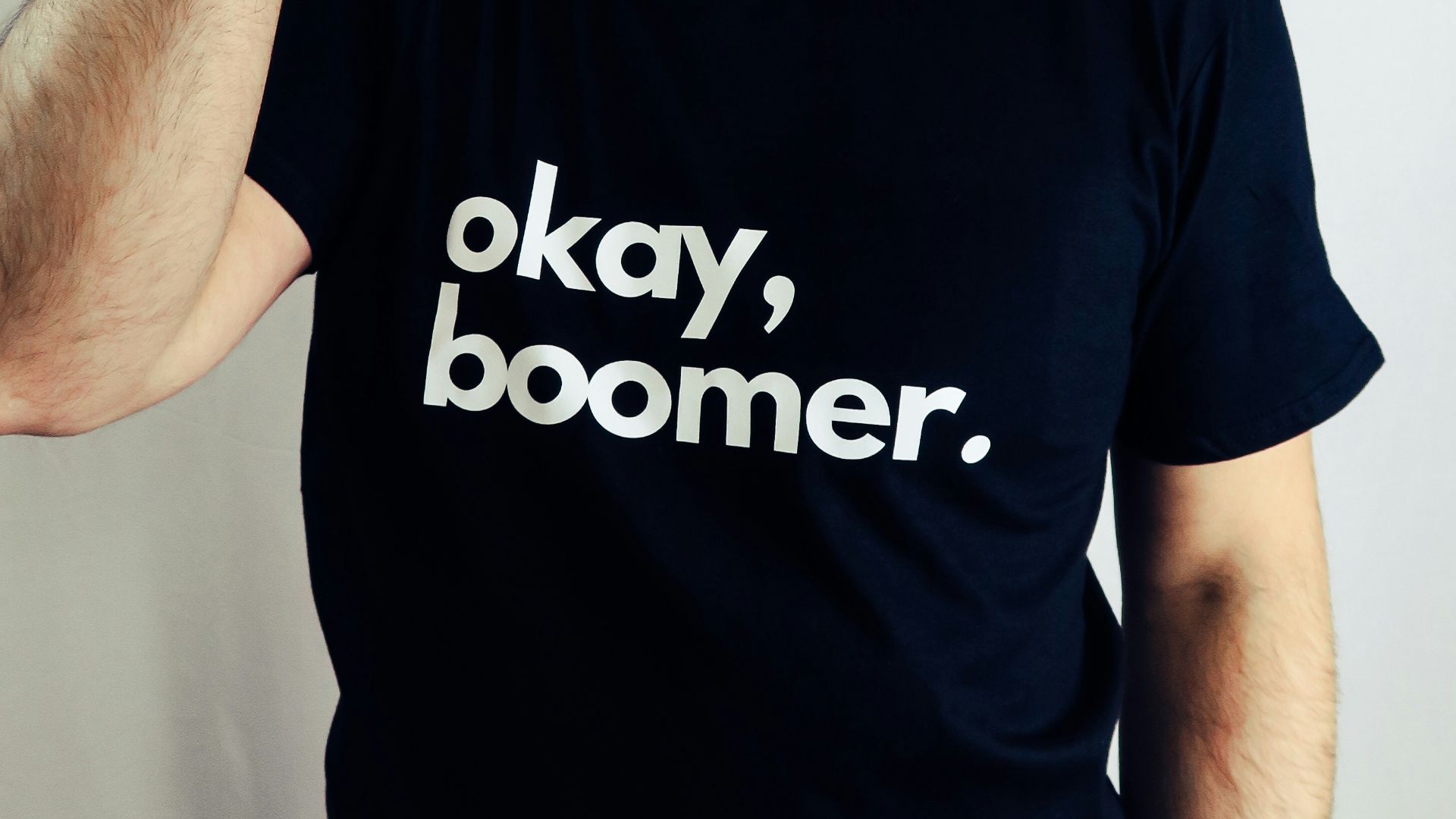 man in black crew neck t-shirt wearing black fedora hat