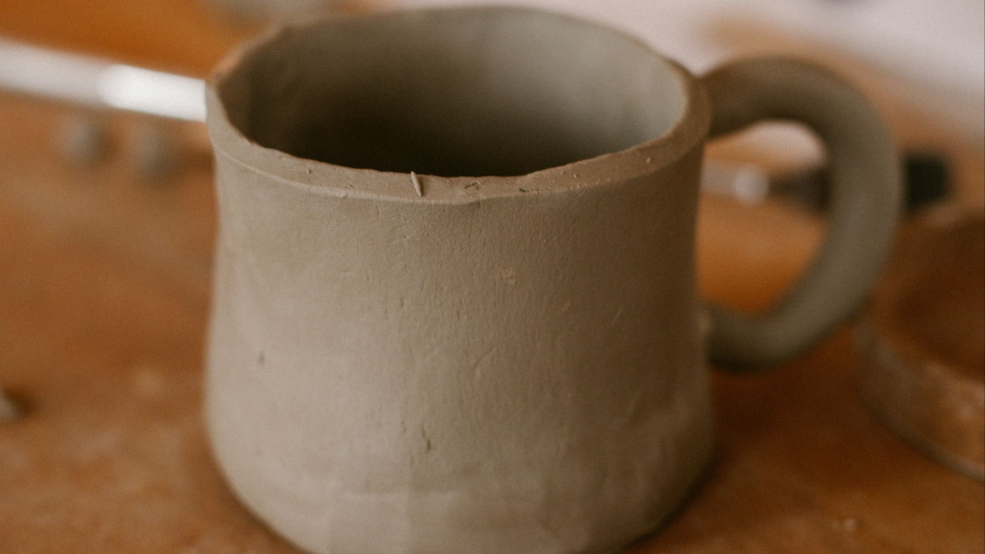 A cup sitting on top of a wooden table