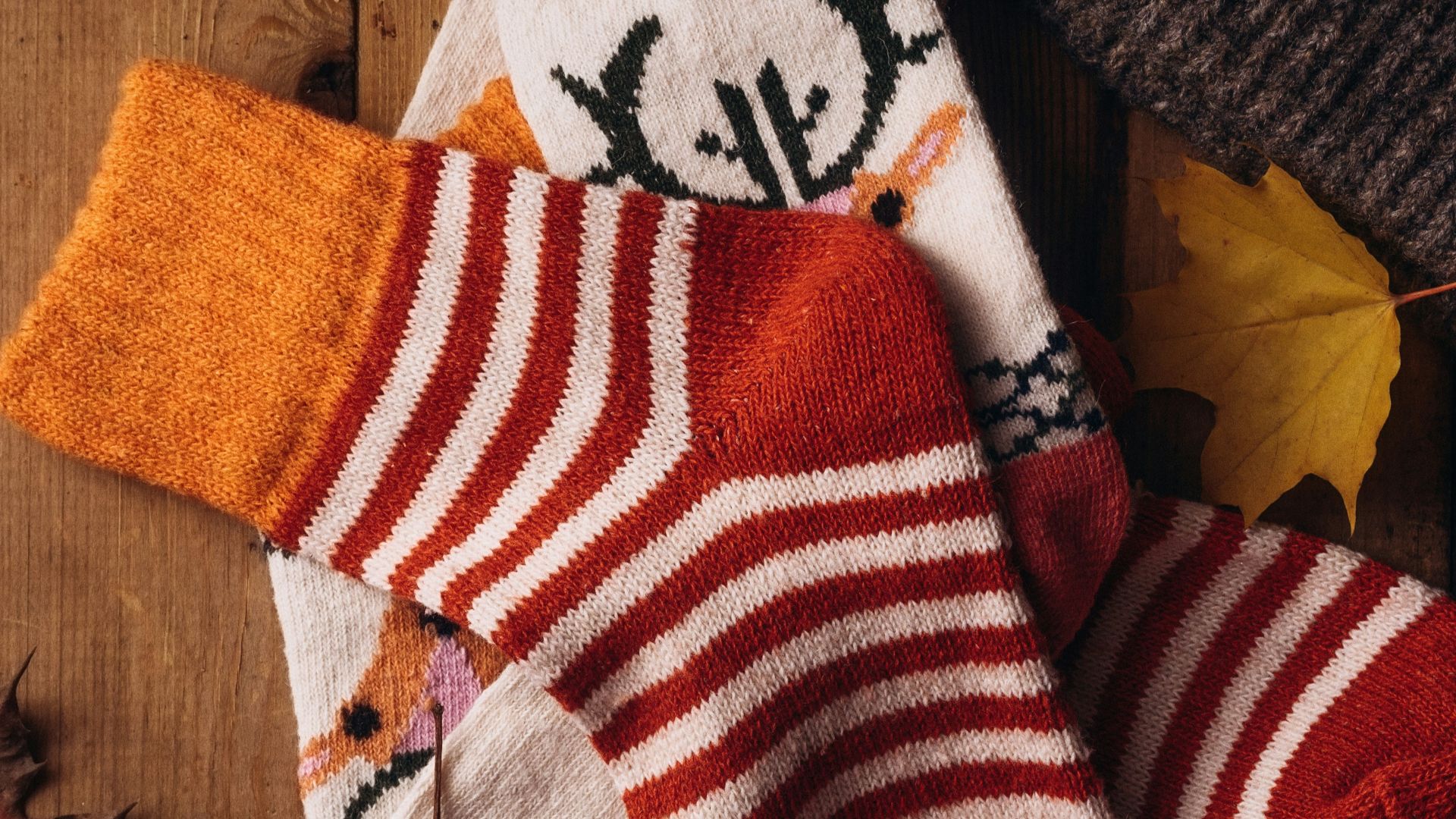 a pair of socks and a hat on a wooden table