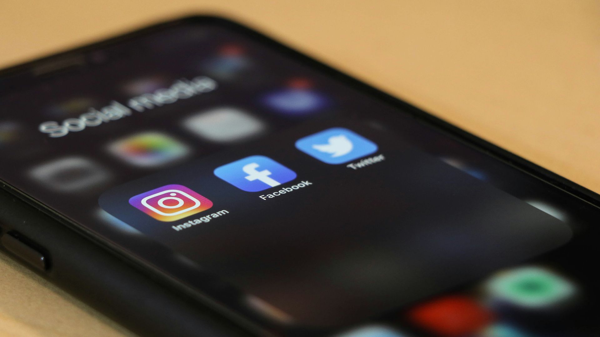 black iphone 4 on brown wooden table