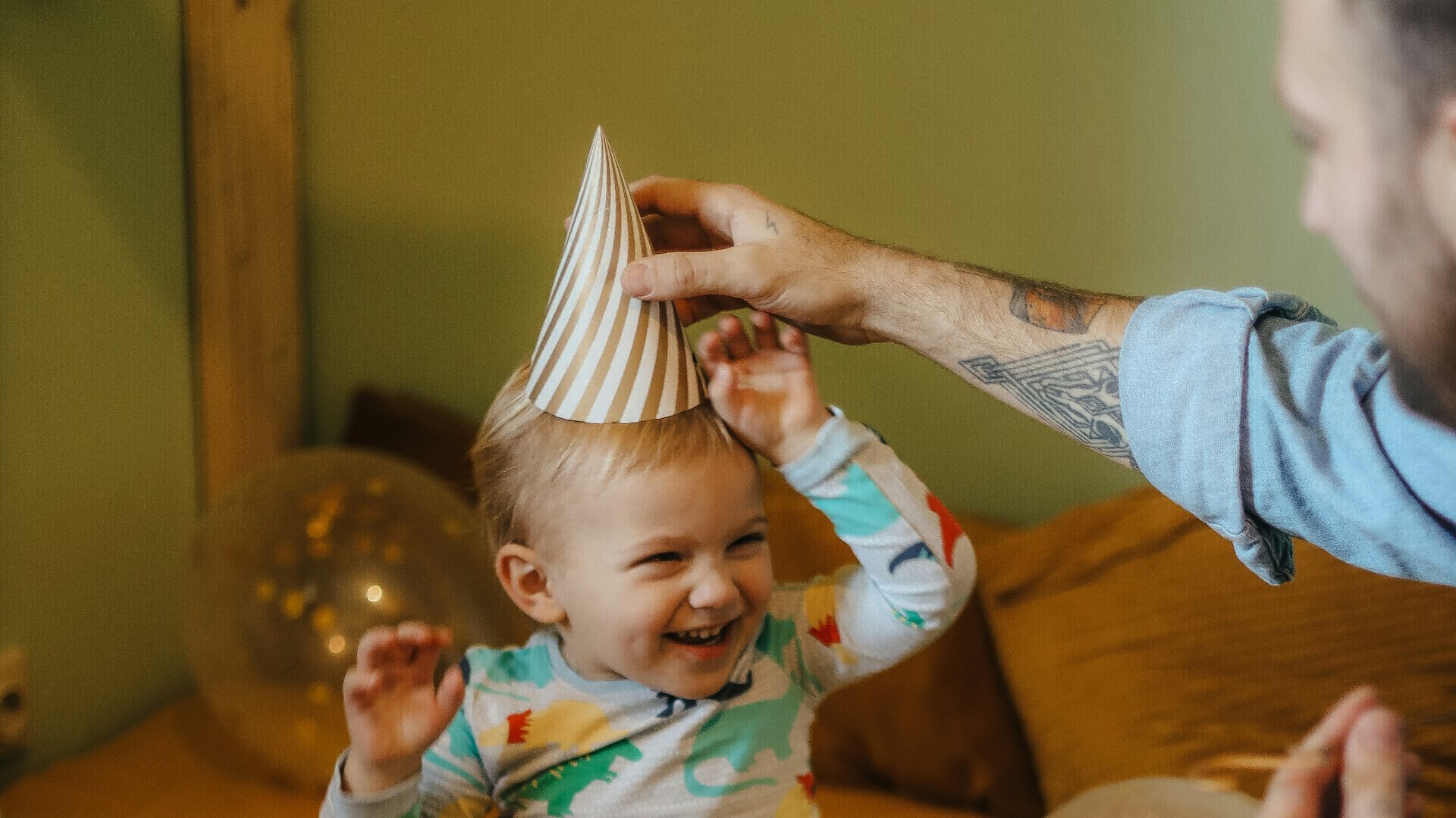 a person and a baby blowing out candles on a cake