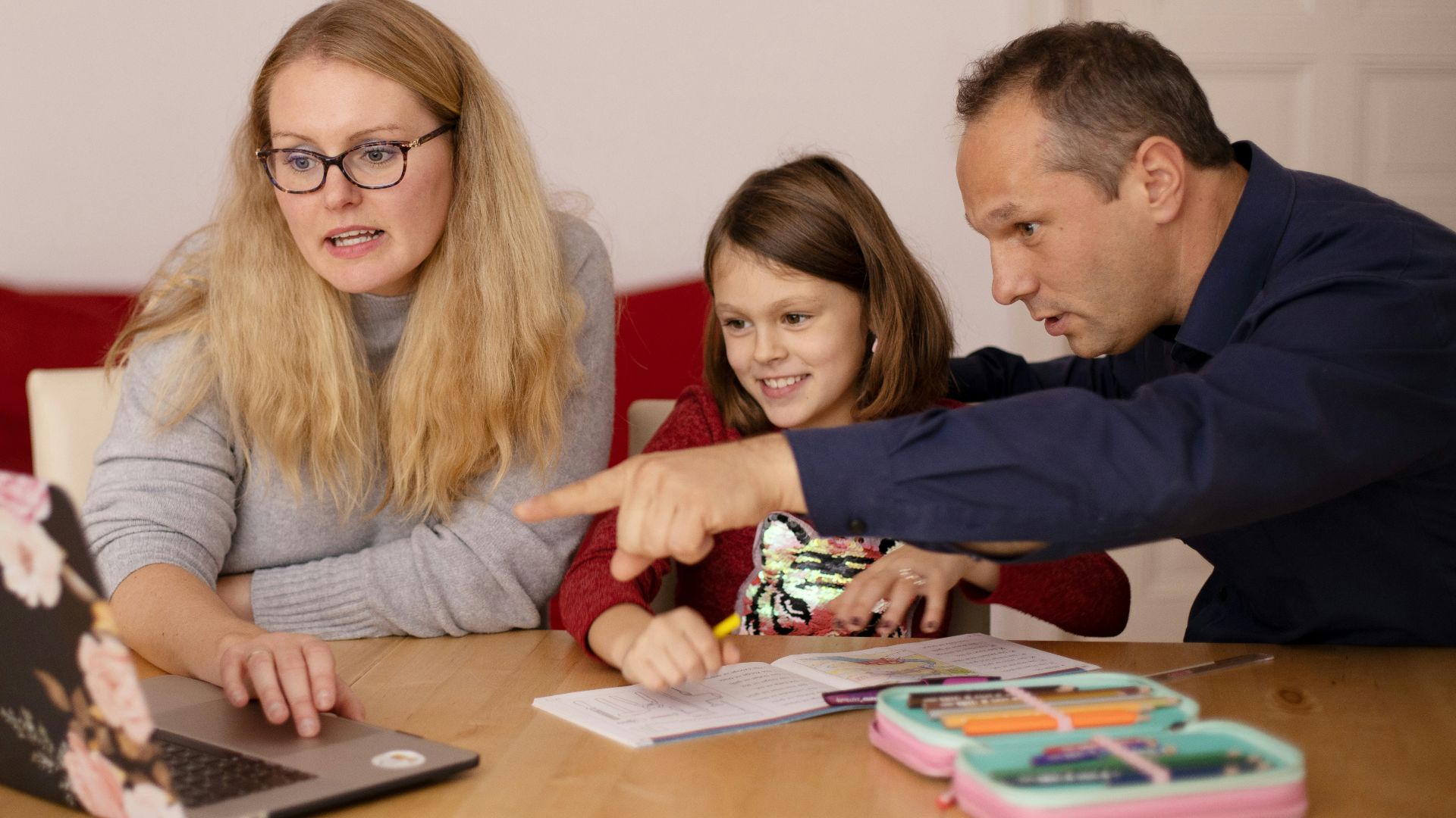 woman in gray long sleeve shirt sitting beside boy in blue sweater