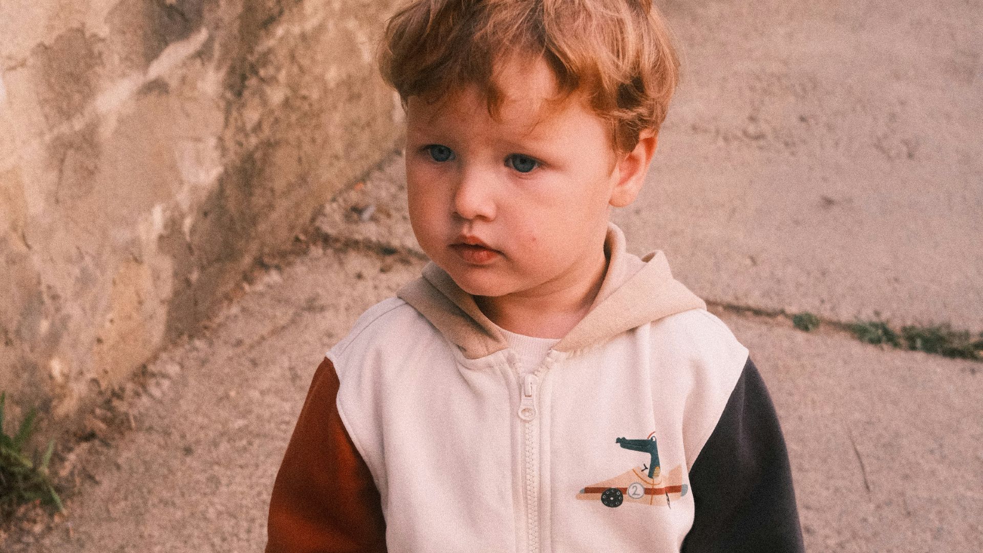 a little boy that is standing on a skateboard