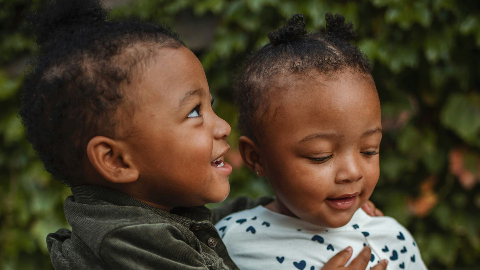 boy and girl surrounded by plants