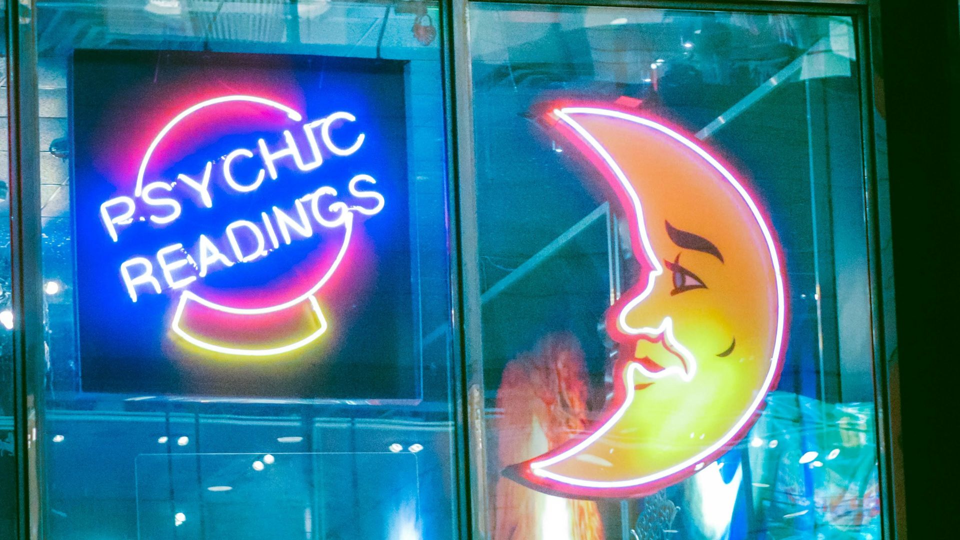 a neon sign in a window of a psychic shop