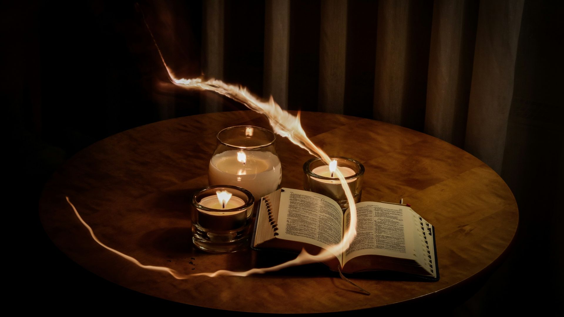 lighted candles beside book