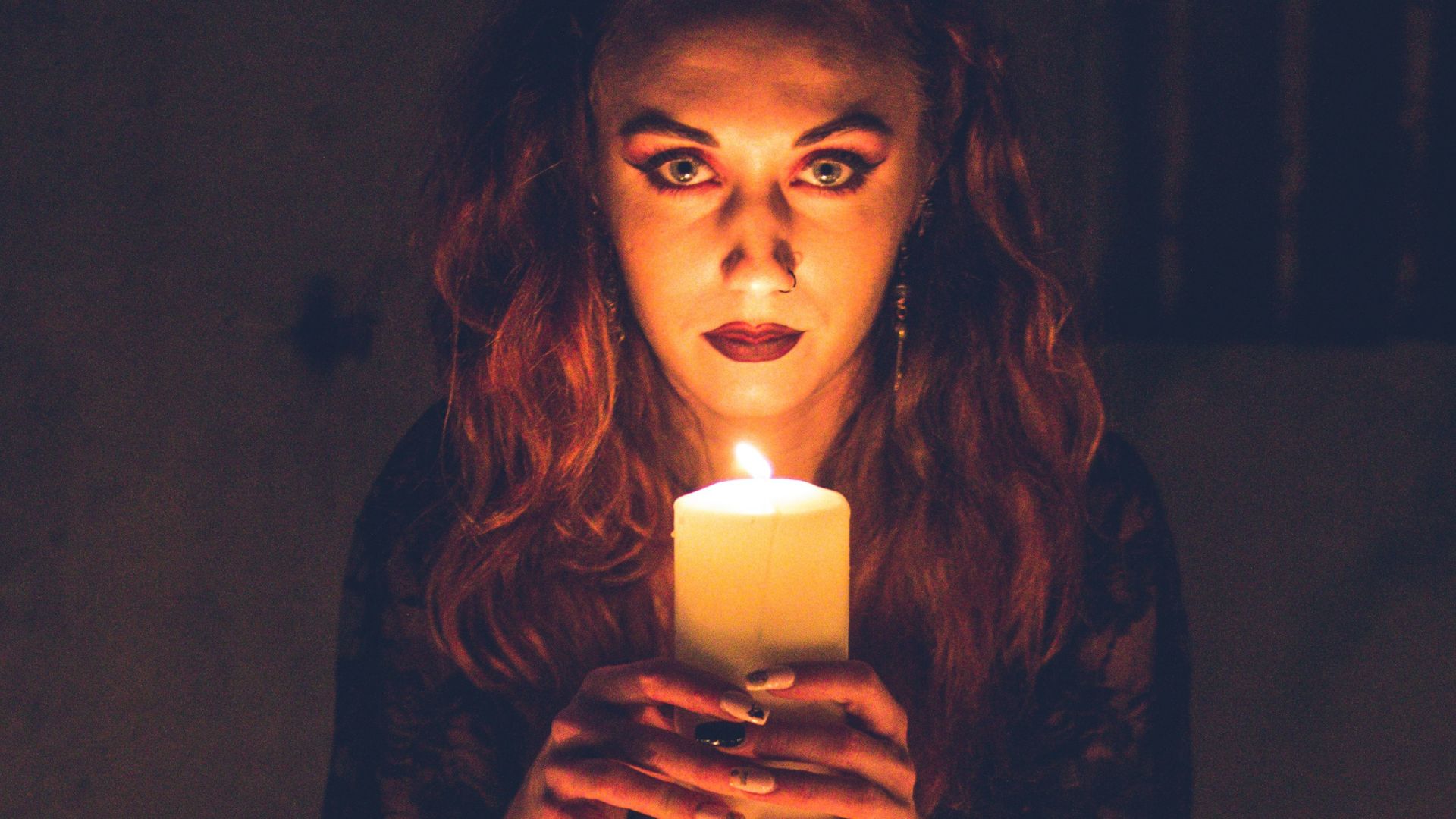 woman in black long sleeve shirt holding white ceramic mug