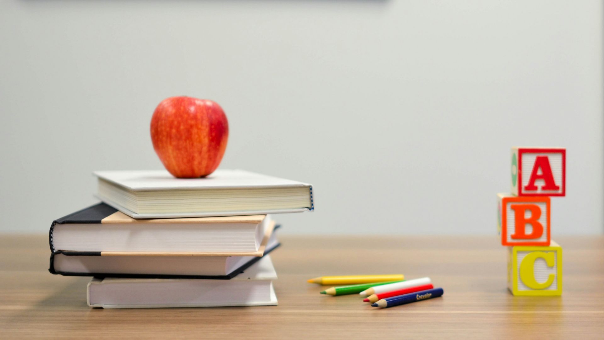 red apple fruit on four pyle books