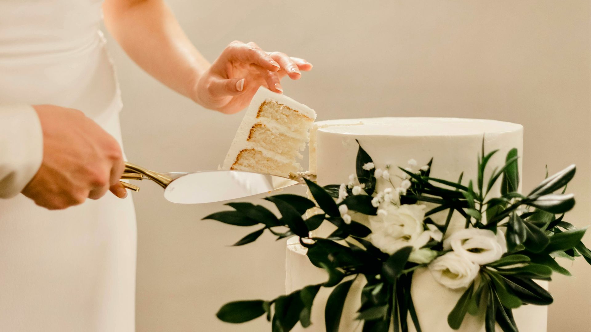 a woman cutting a cake