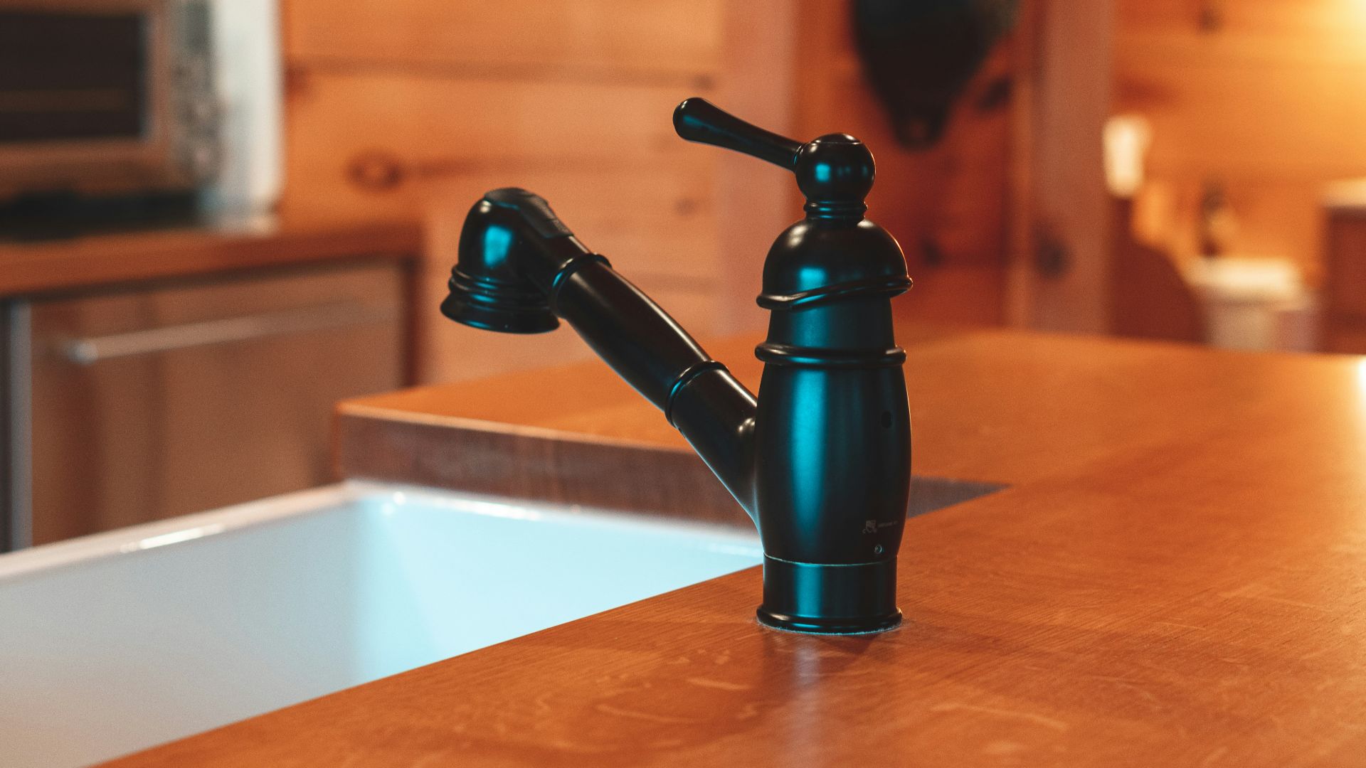 black and silver vacuum flask on brown wooden table