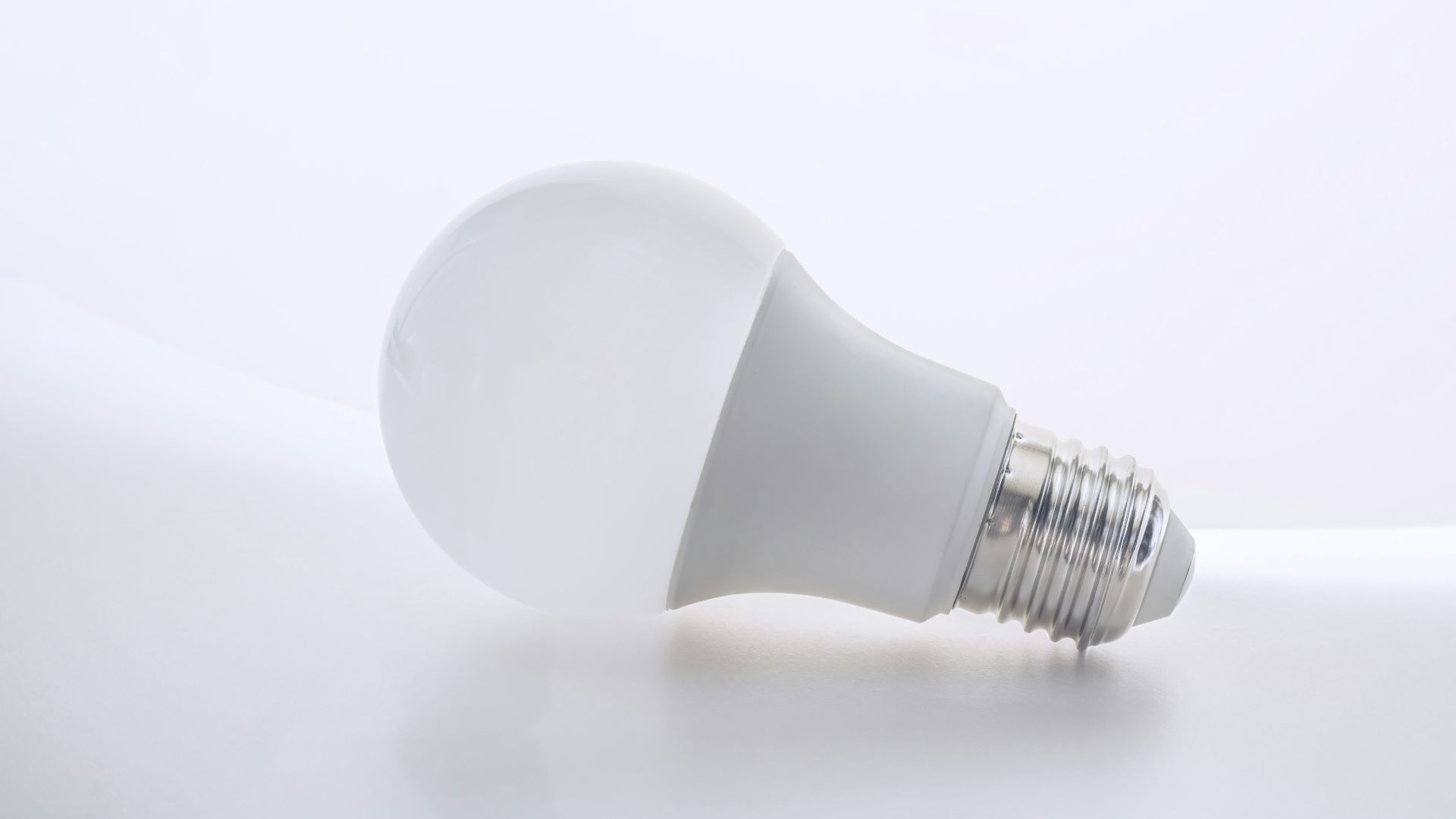 a white light bulb sitting on top of a white table
