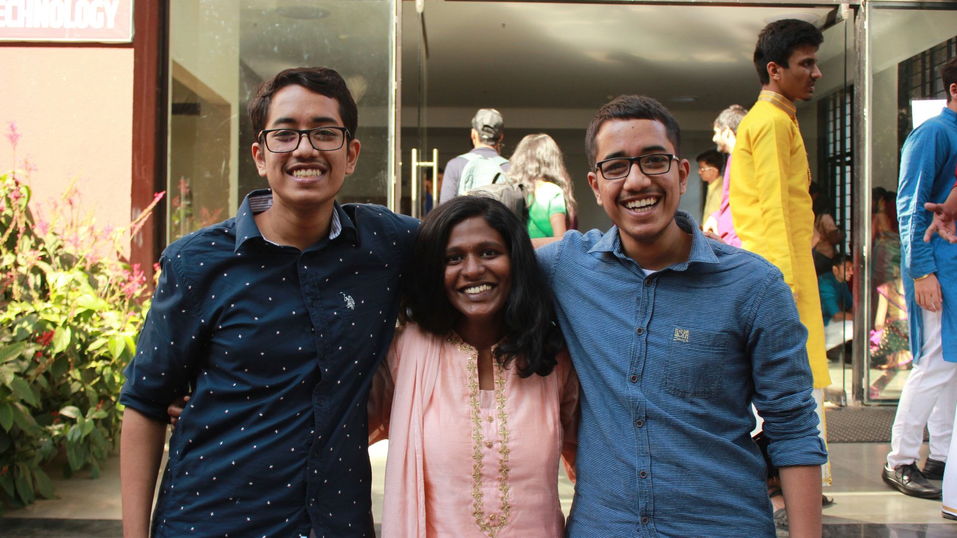 man in blue dress shirt beside woman in pink floral dress
