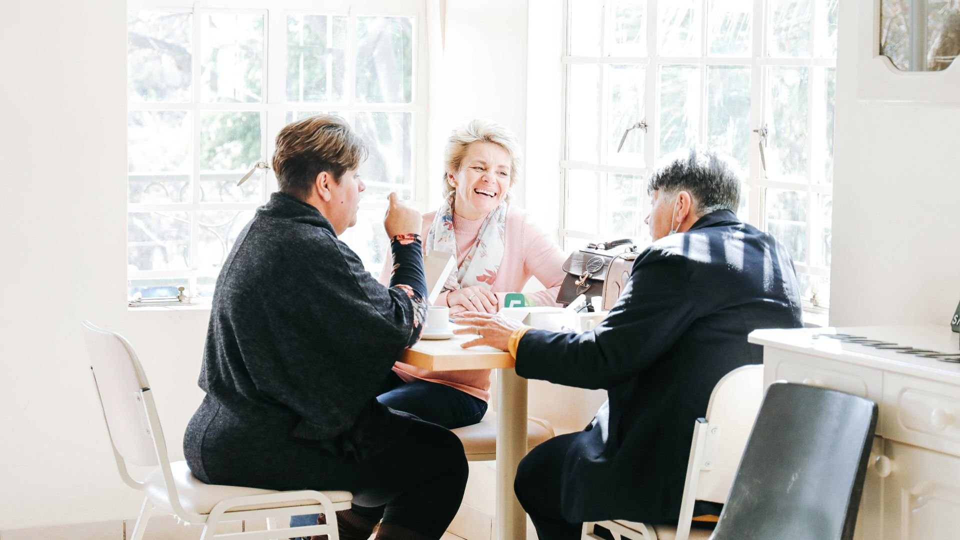 a group of people sitting around a table
