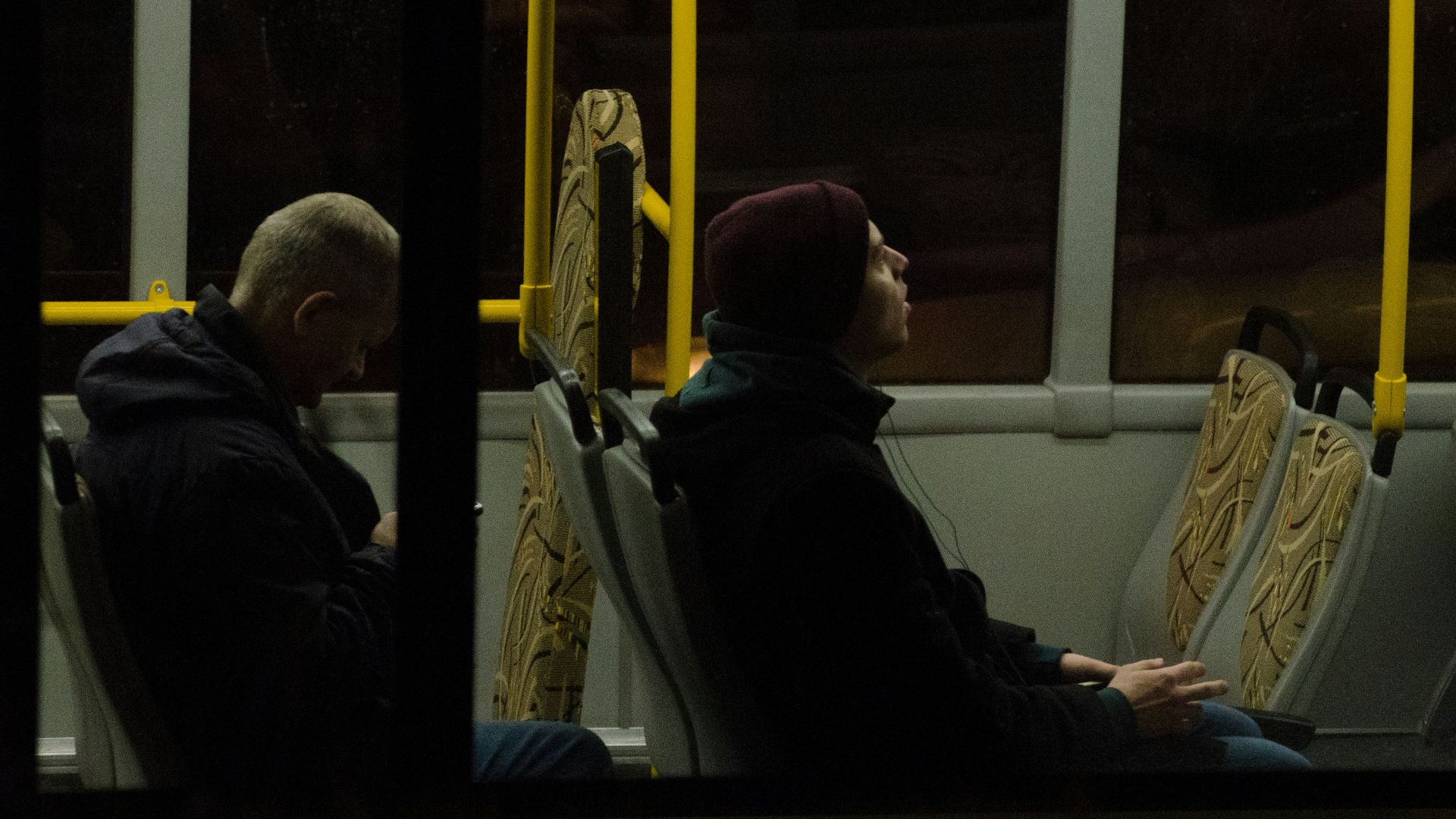 men sitting on bus seat