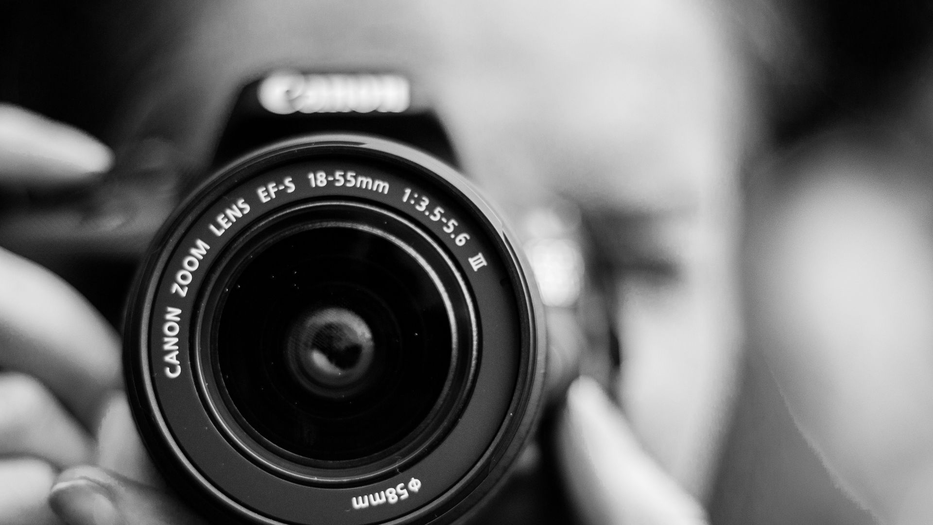 person taking photo using Canon camera in shallow focus lens