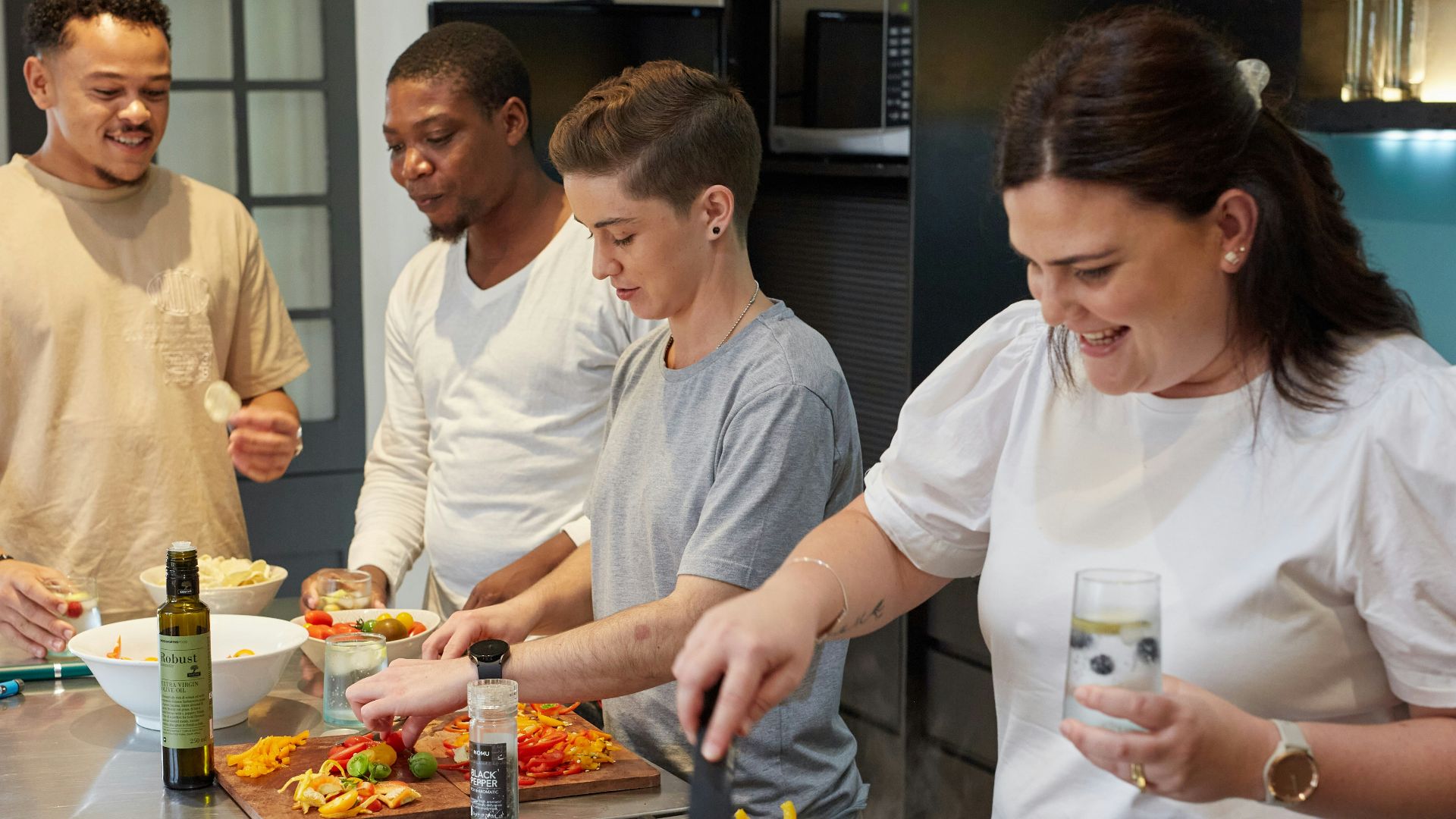 a group of people preparing food in a kitchen