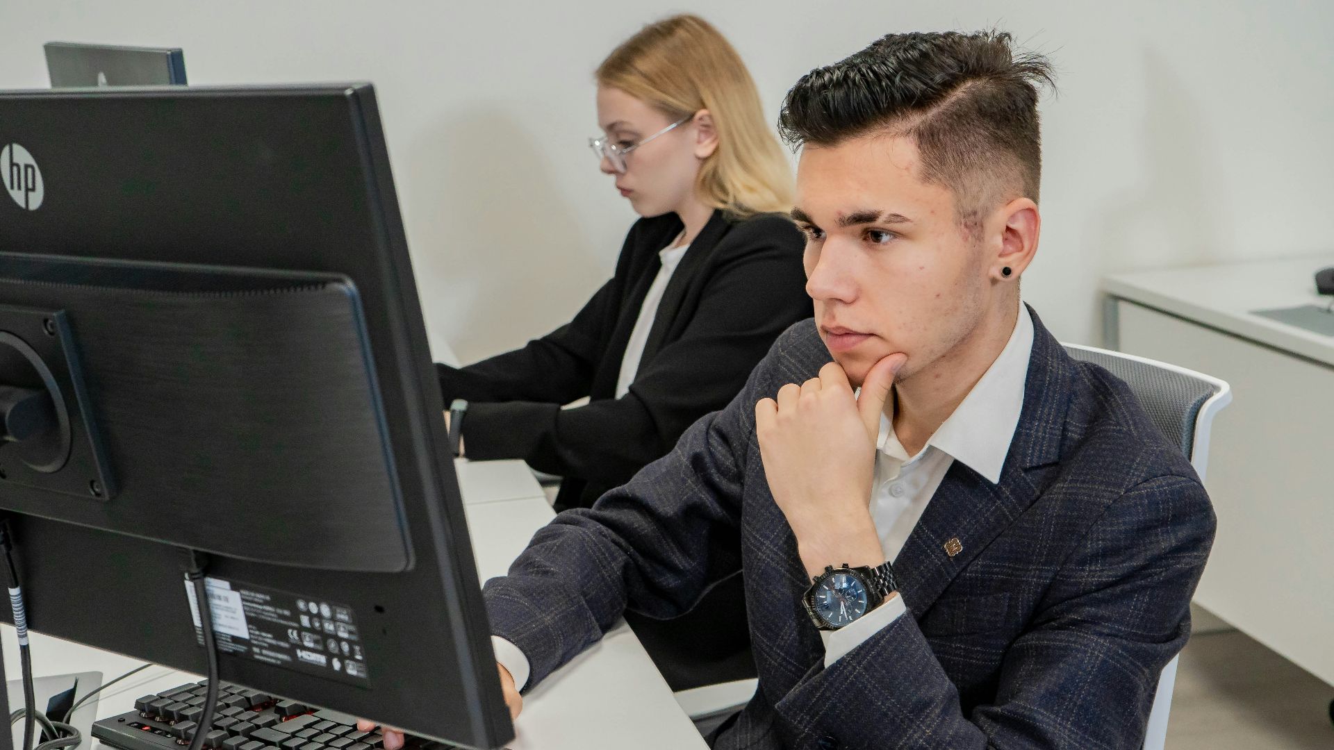 a man sitting at a desk in front of a computer