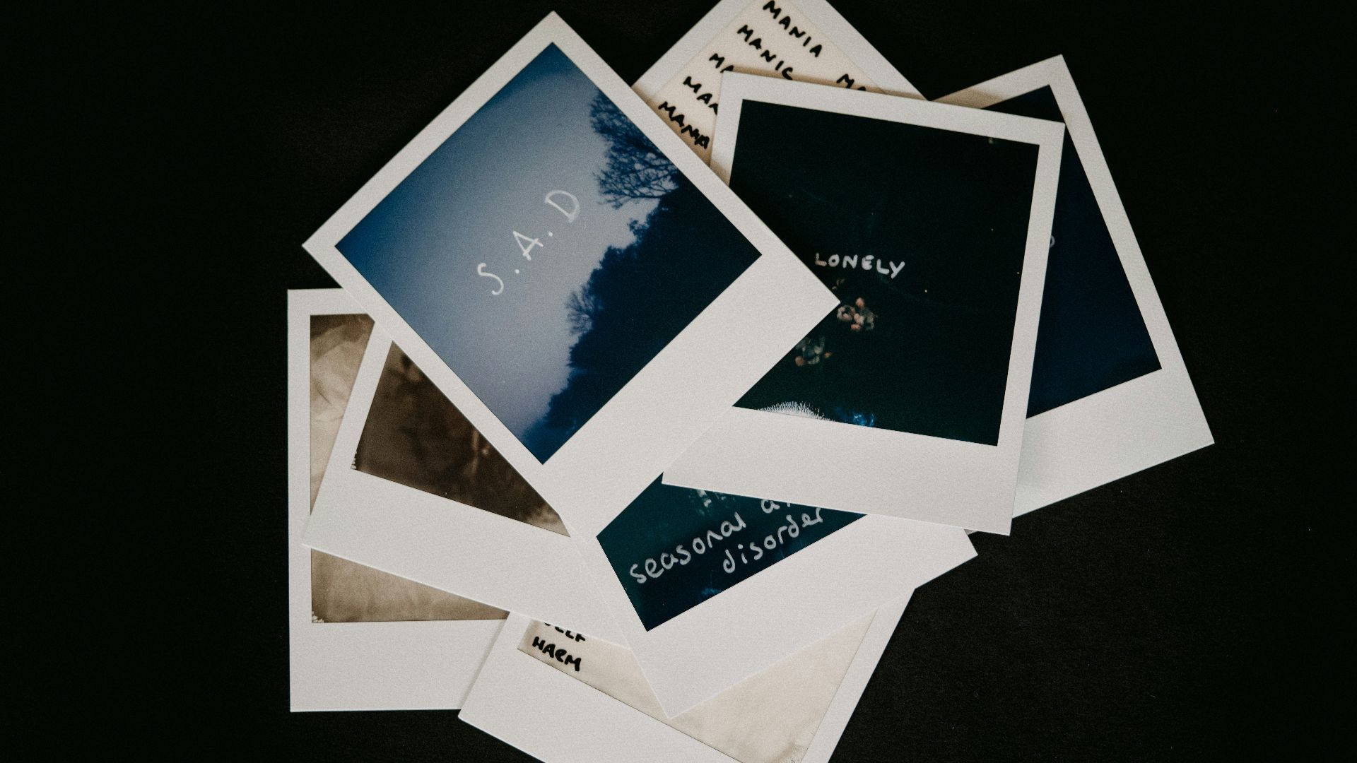 white and blue cards on black surface