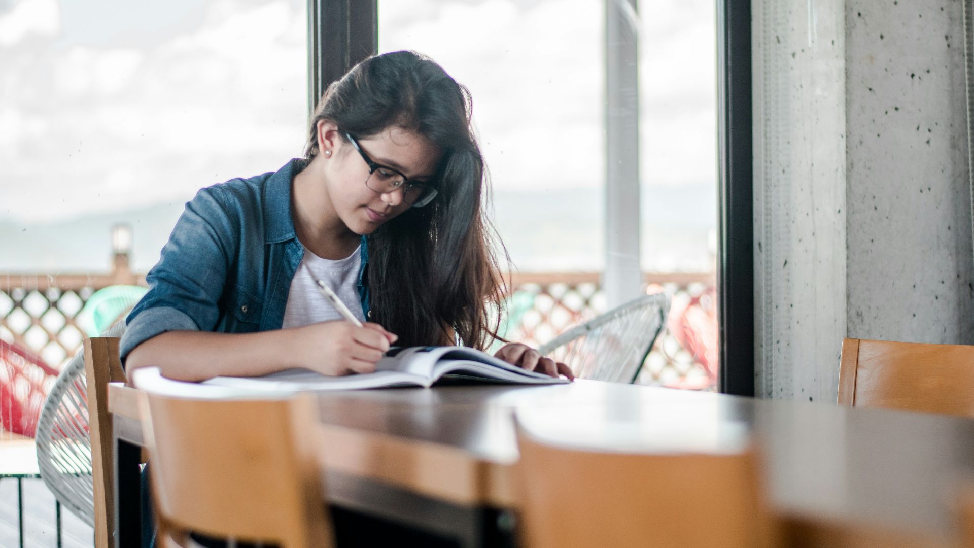 woman writing on book