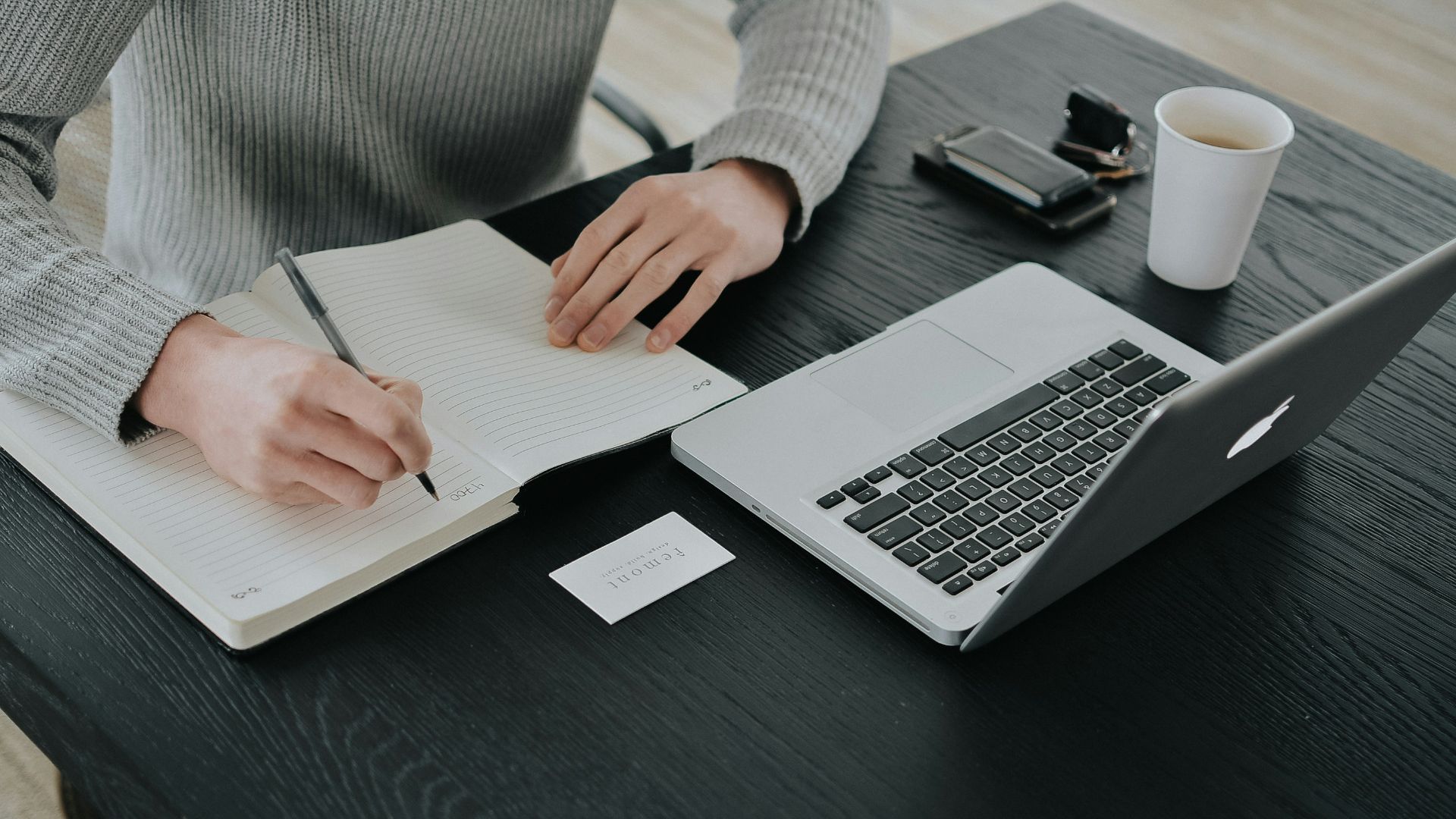 person in white dress shirt holding white paper