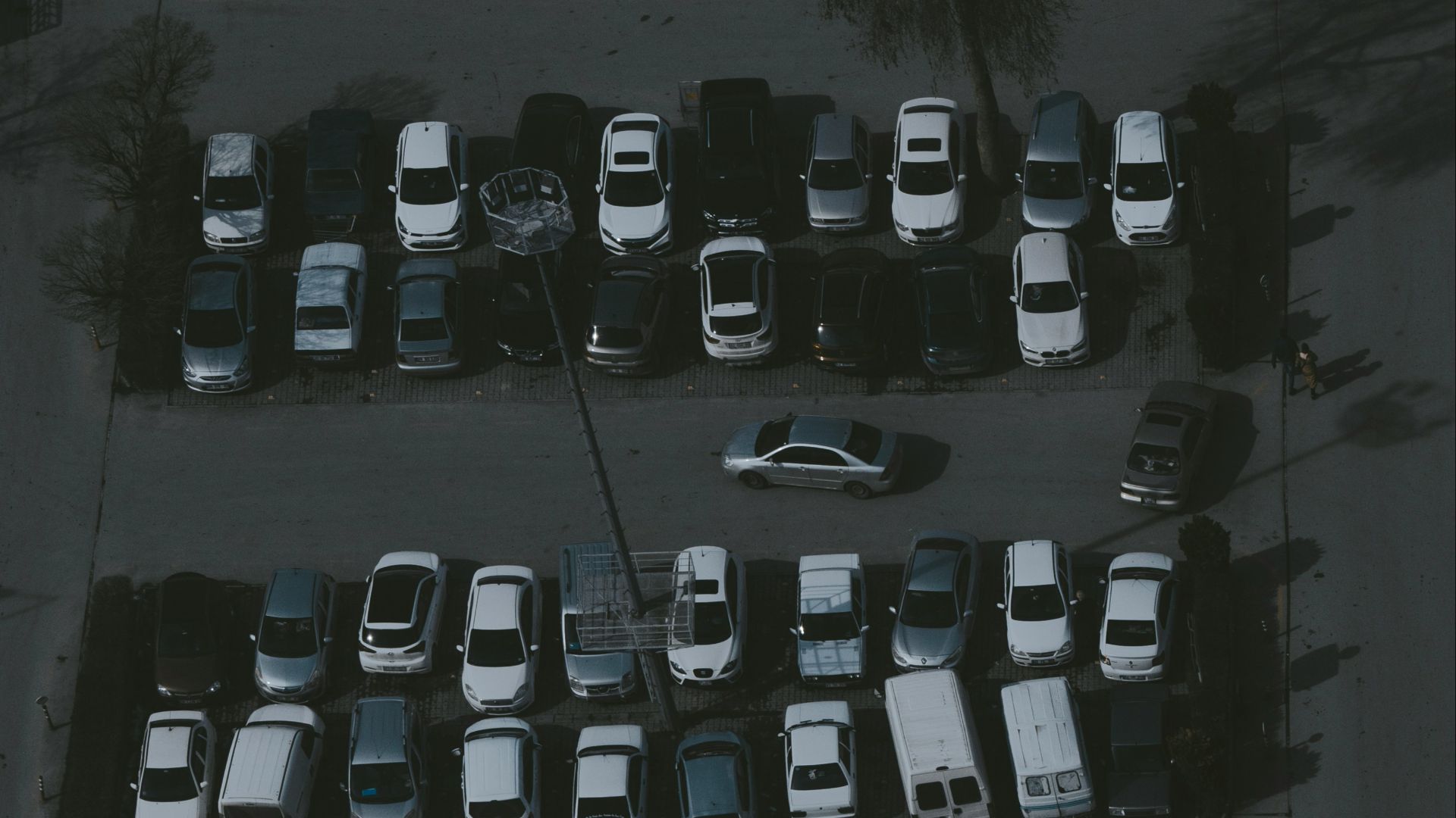 a parking lot filled with lots of parked cars