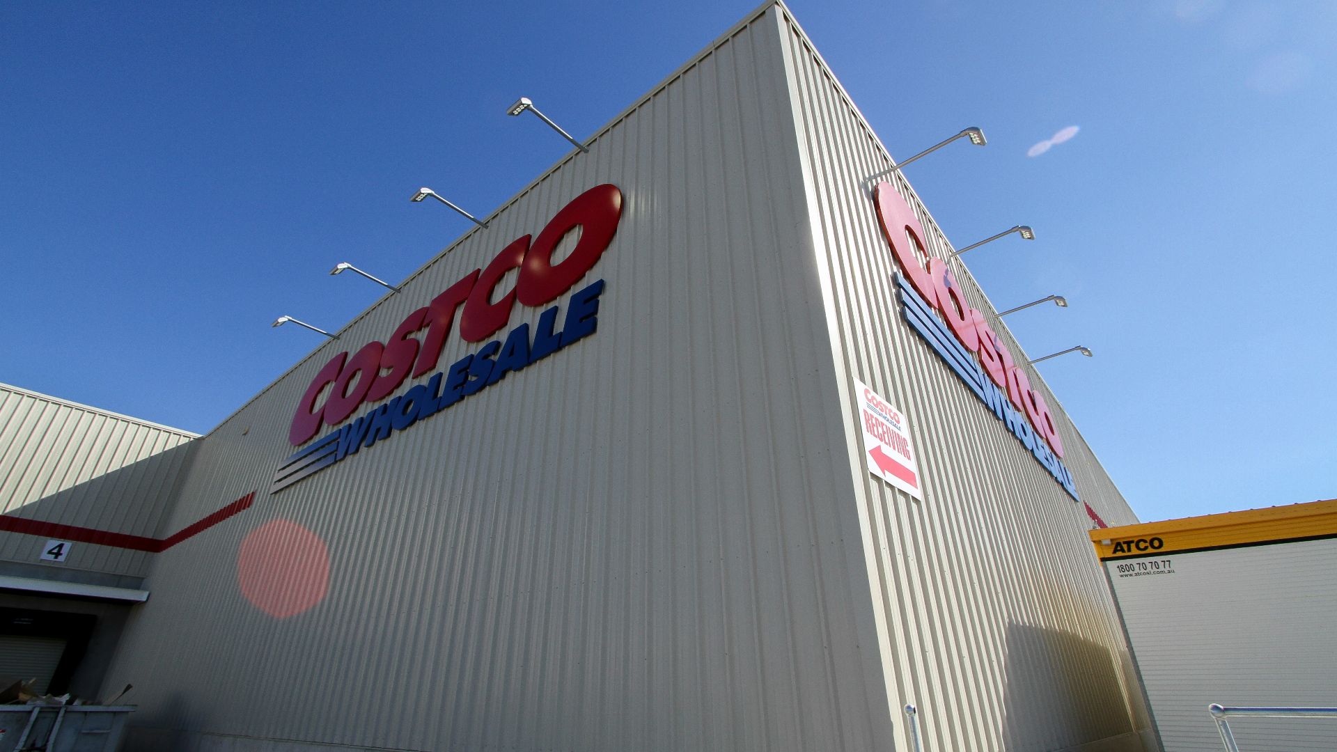 a large white building with a red and blue sign on it