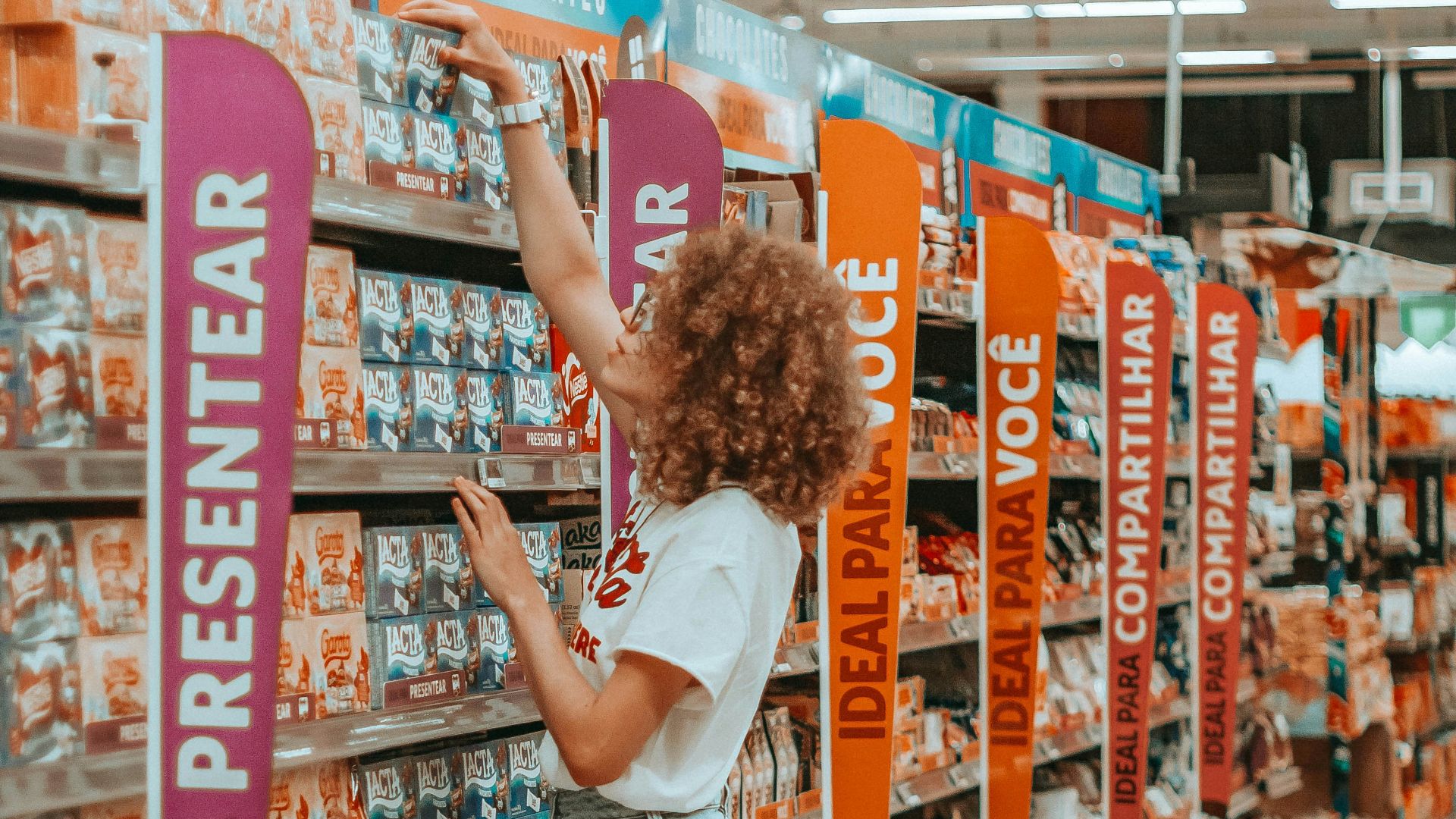 woman getting box of chocolate inside grocery