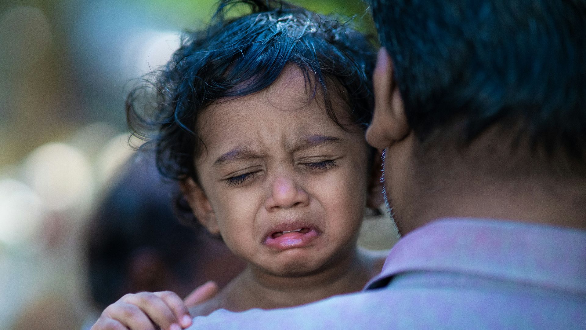 a woman holding a child with a surprised look on her face