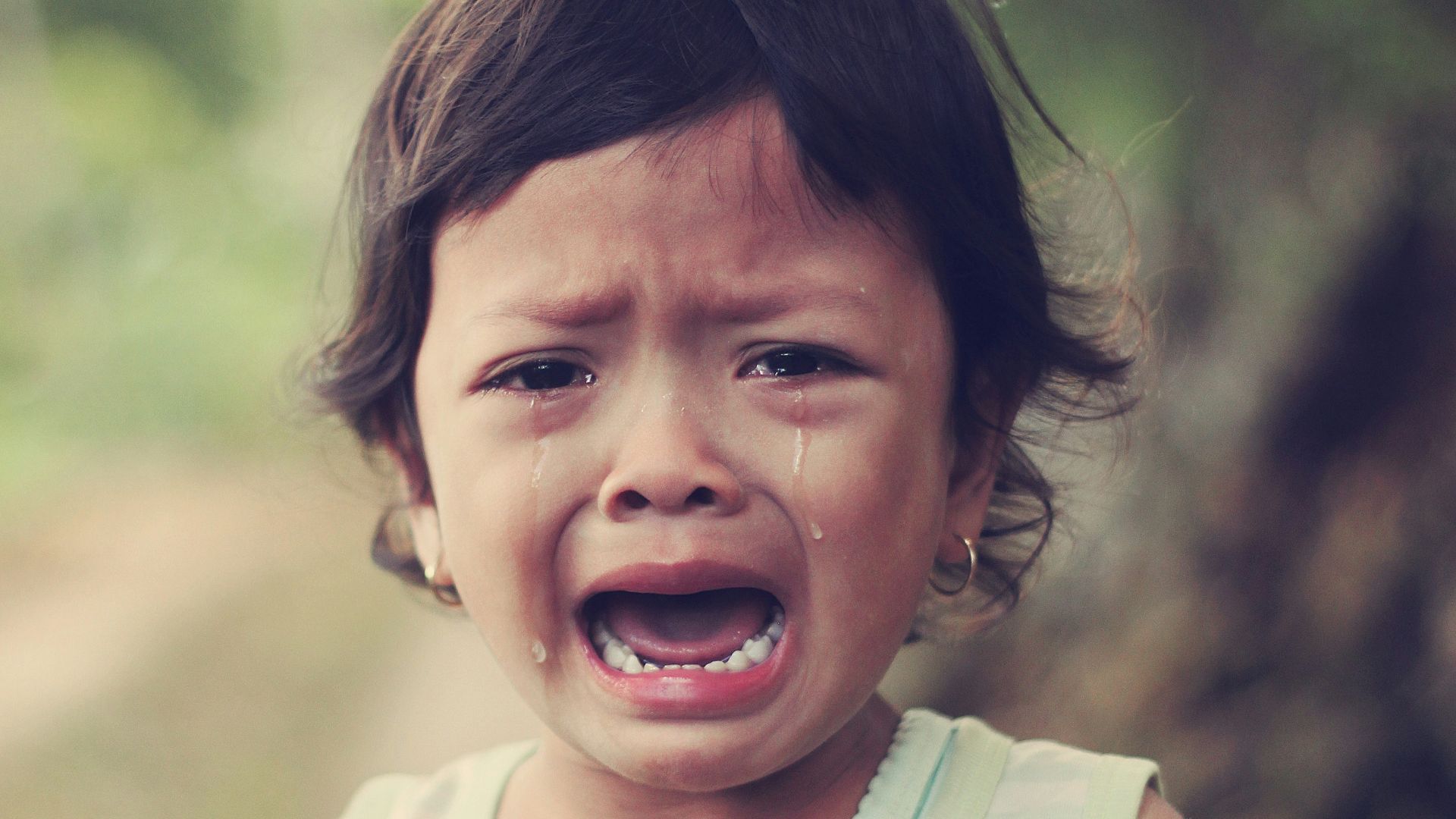 selective focus photography of girl crying