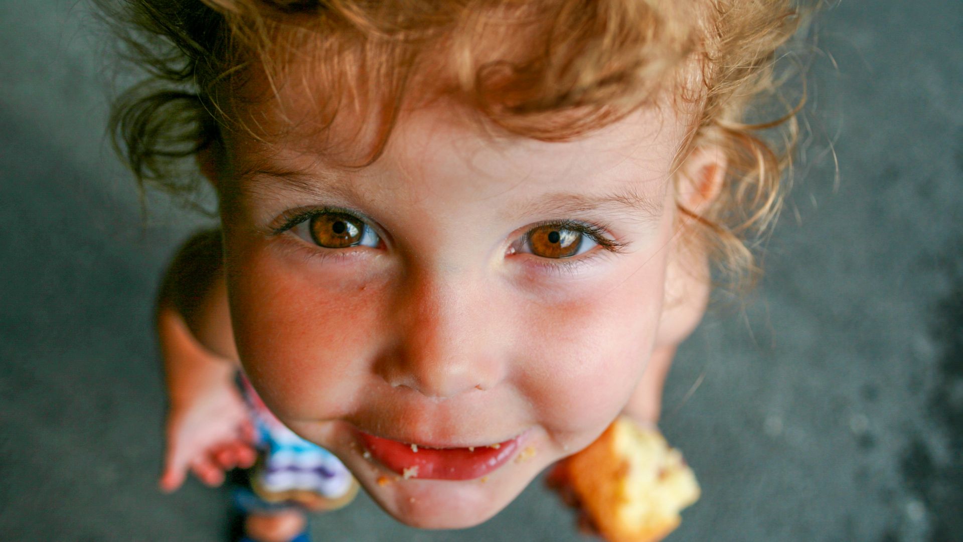 A cute child smiles at the camera.