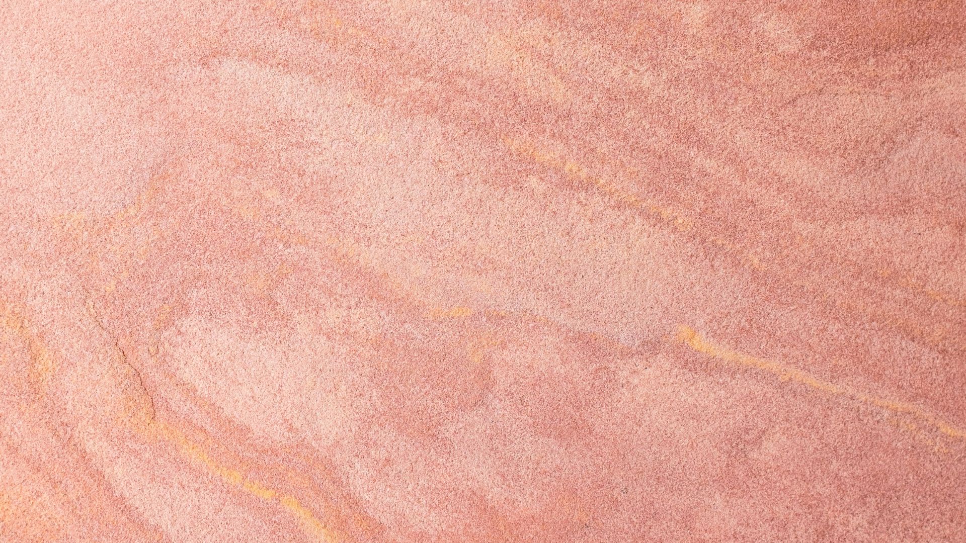 a skateboarder is riding on a pink surface