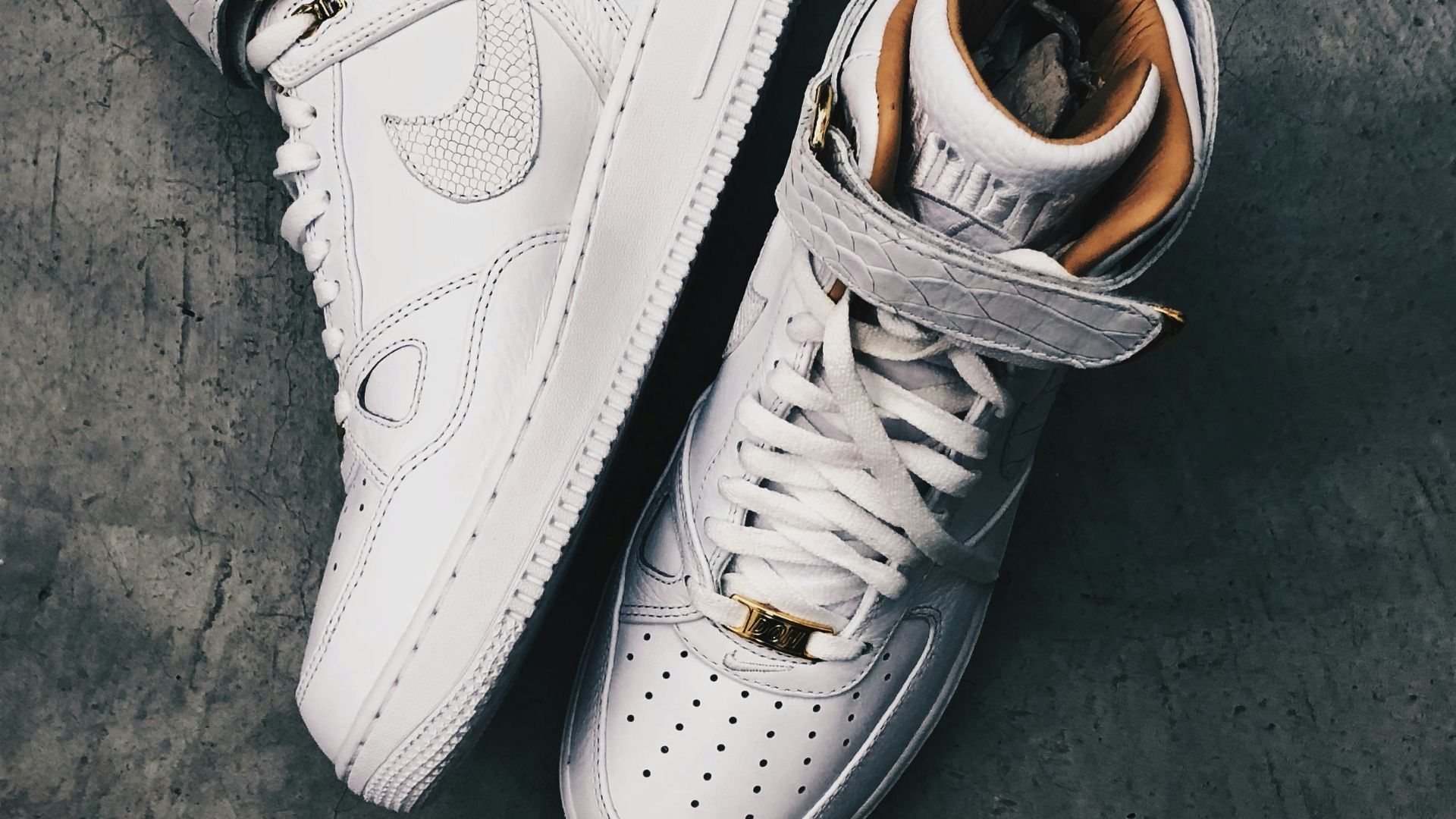 pair of white Nike high-top shoes