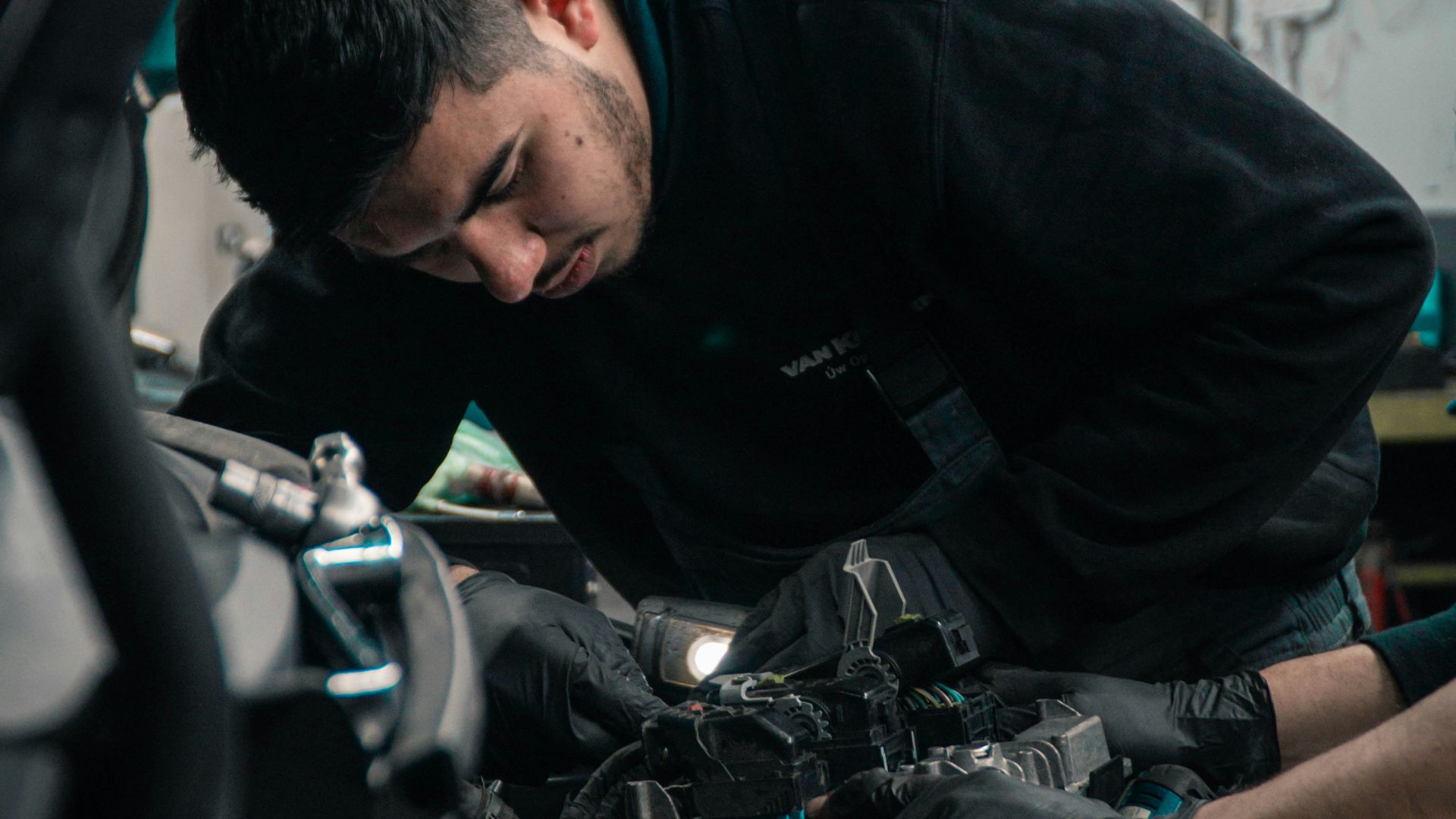 man in black jacket and blue denim jeans riding motorcycle