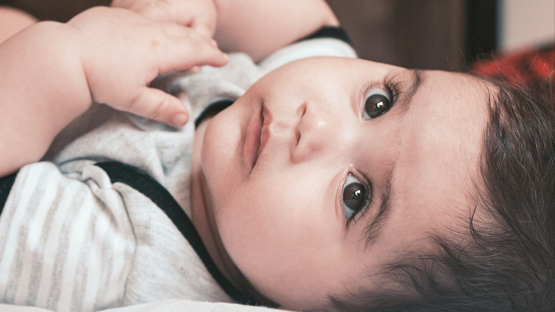 baby in white and pink shirt