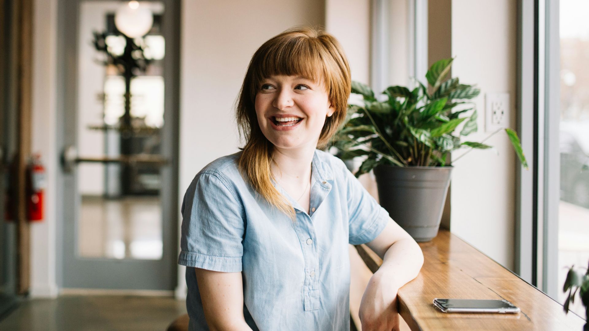 woman sitting in front of brown wooden table