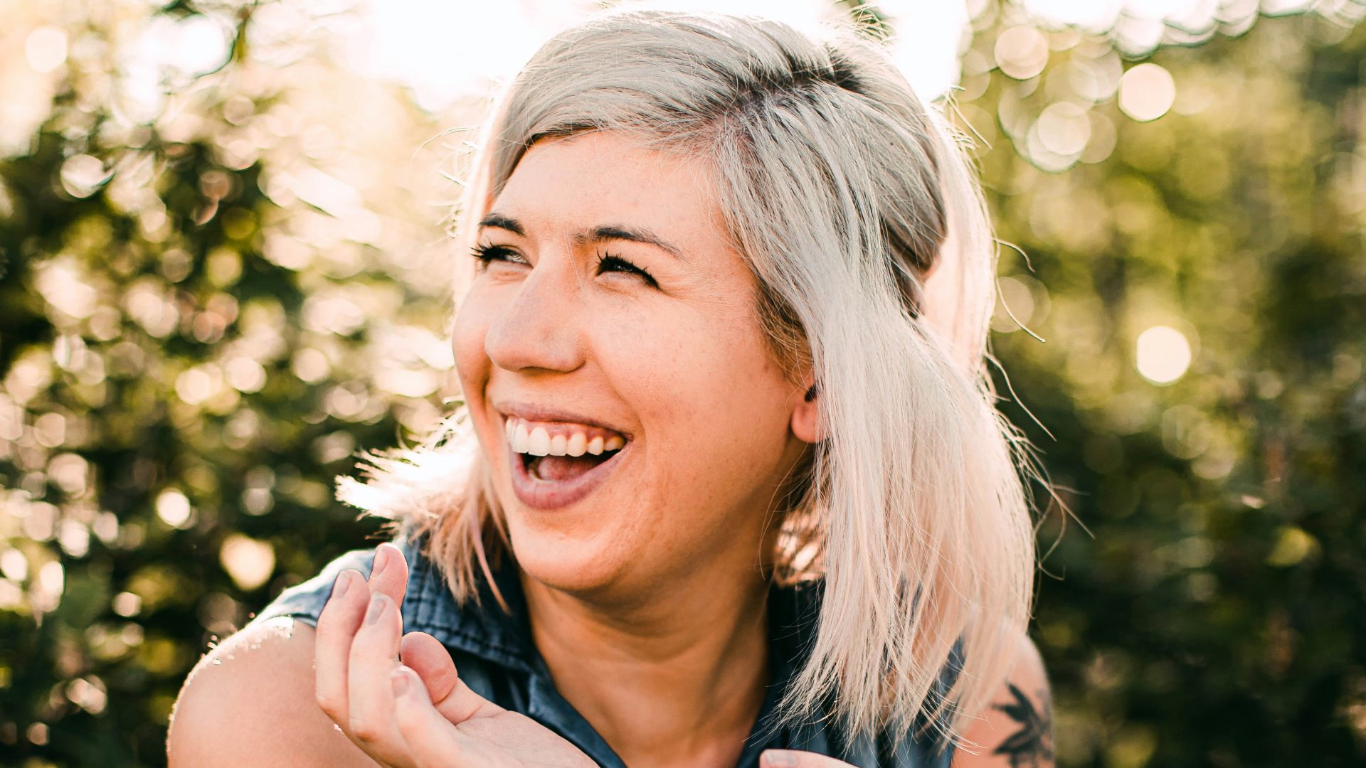 woman in black tank top smiling