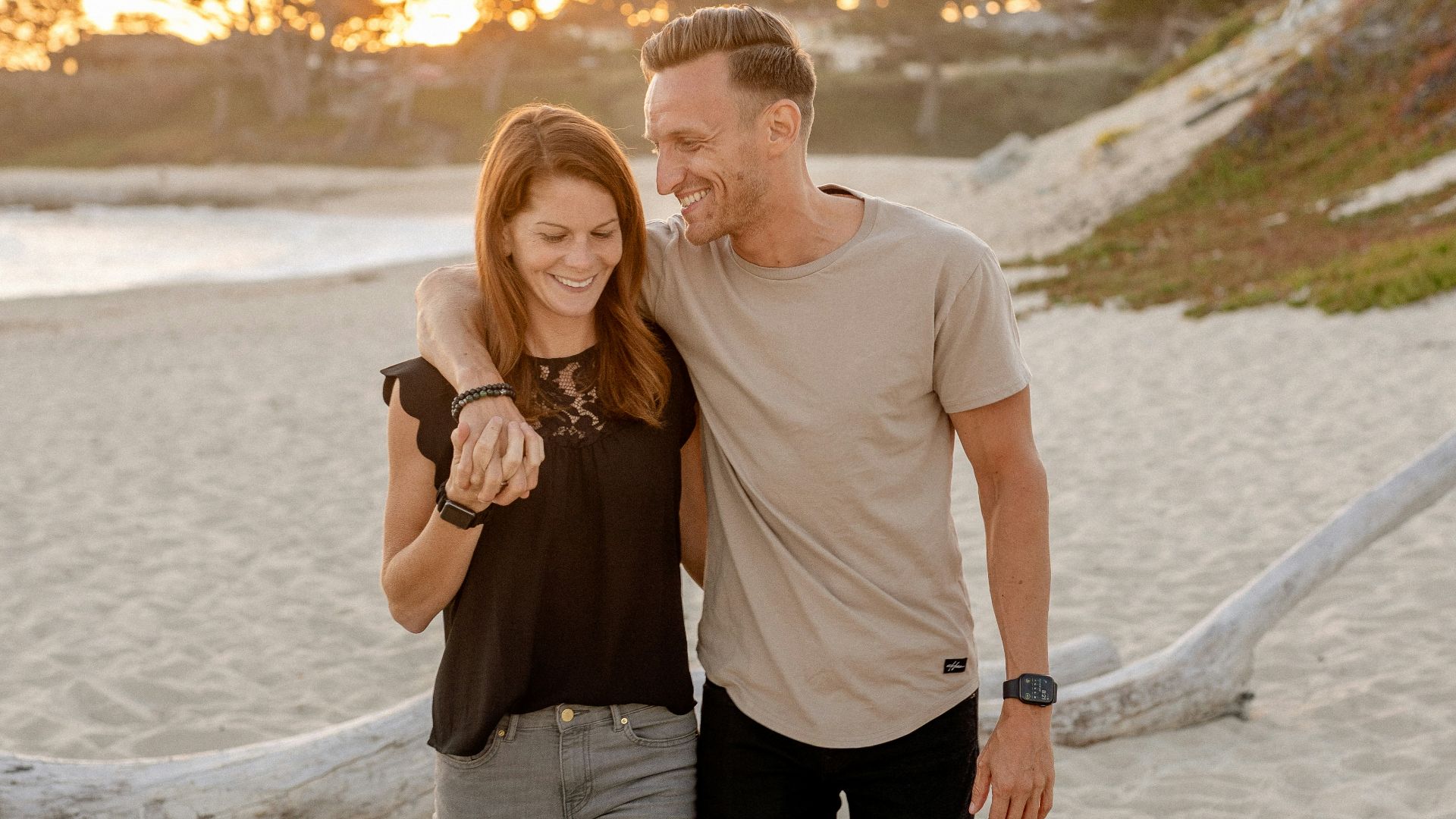 man and woman standing on beach during daytime