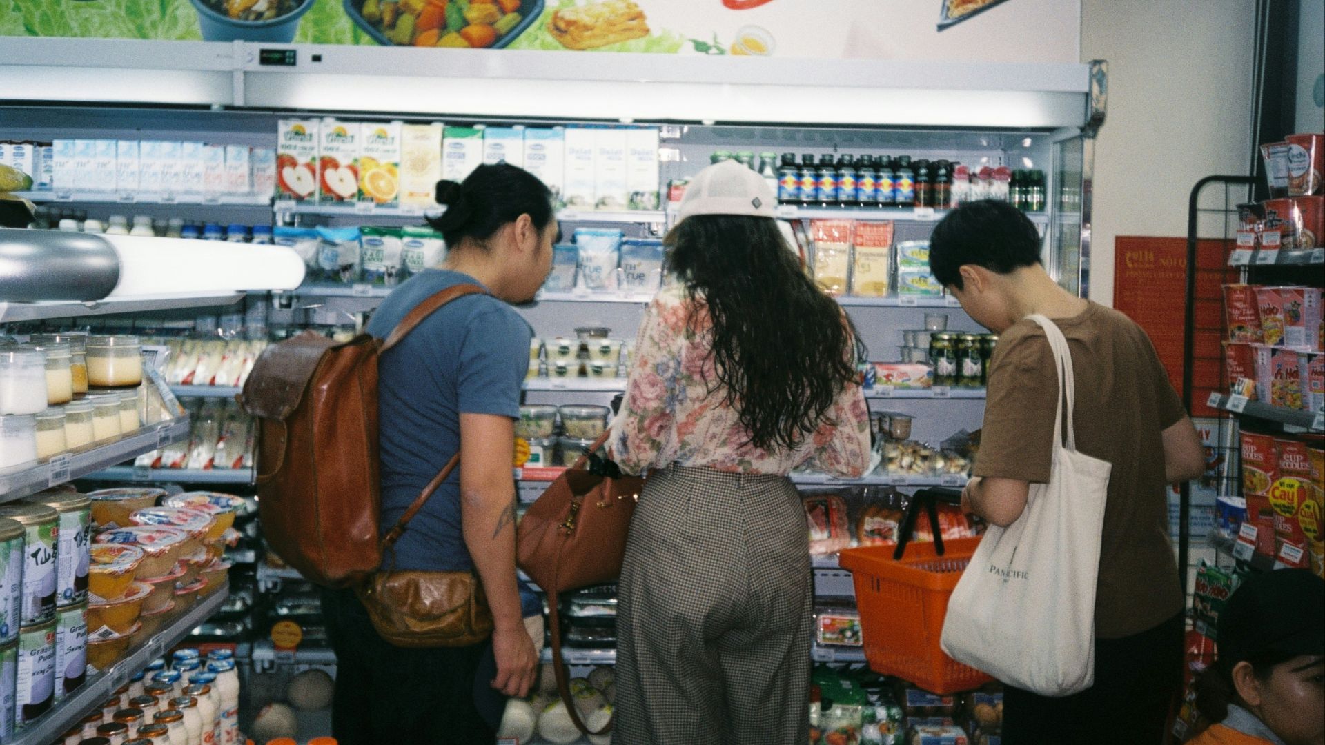 woman in brown long sleeve shirt and gray pants standing in front of white counter