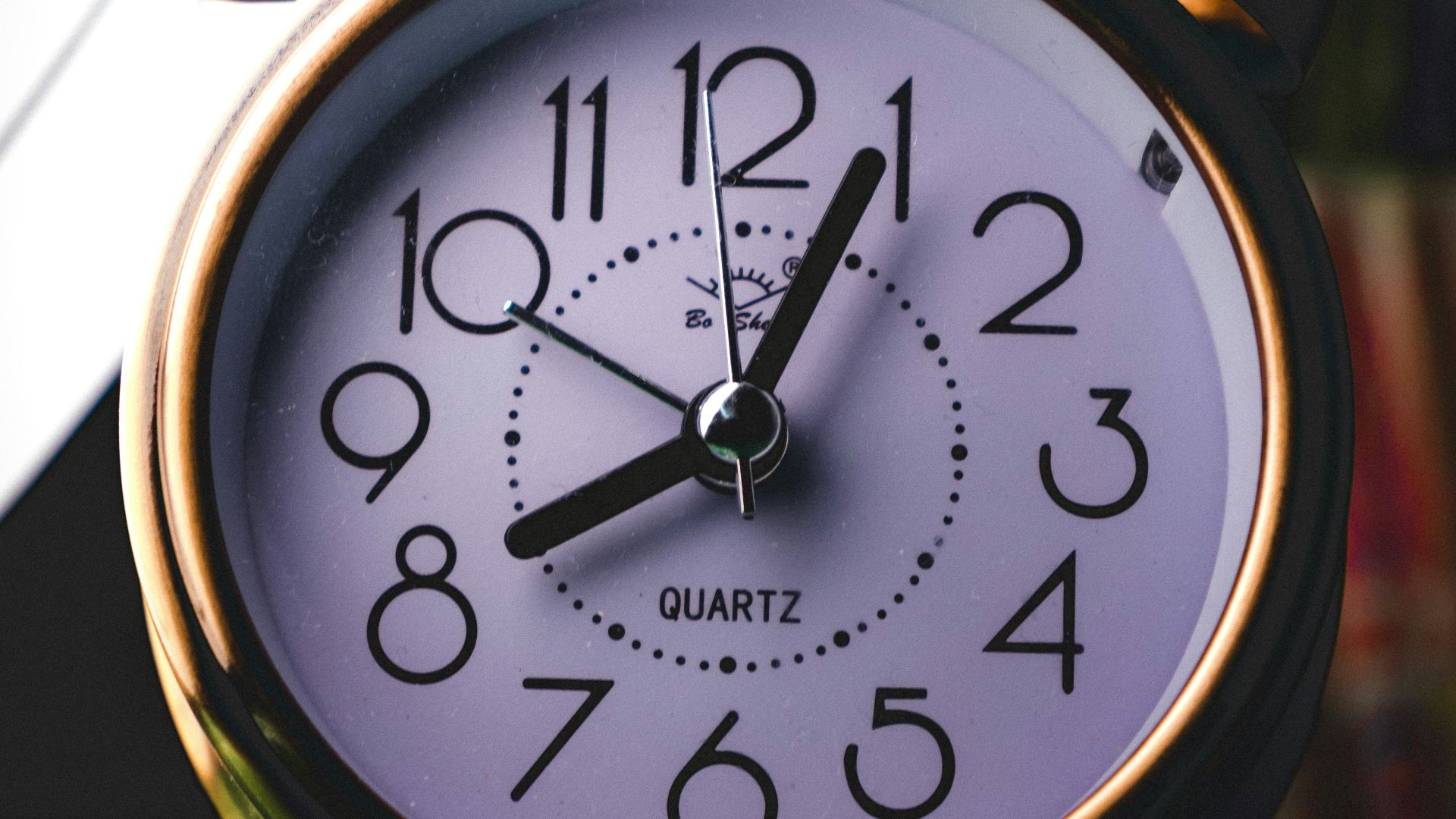 silver twin-bell alarm clock at 8:05