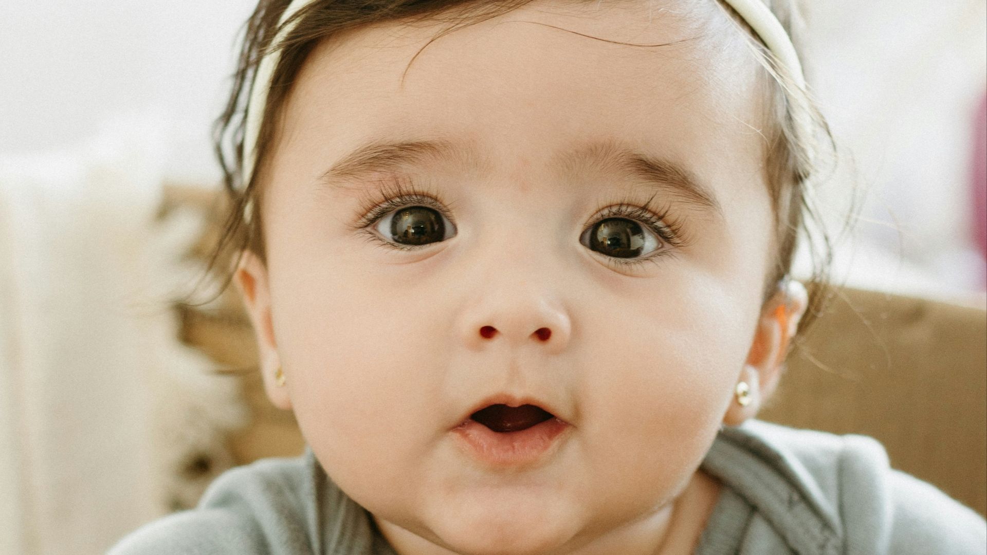 A baby girl sitting in a cardboard box