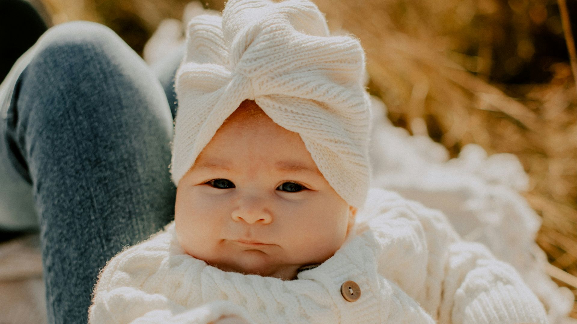 a close up of a baby holding a stuffed animal