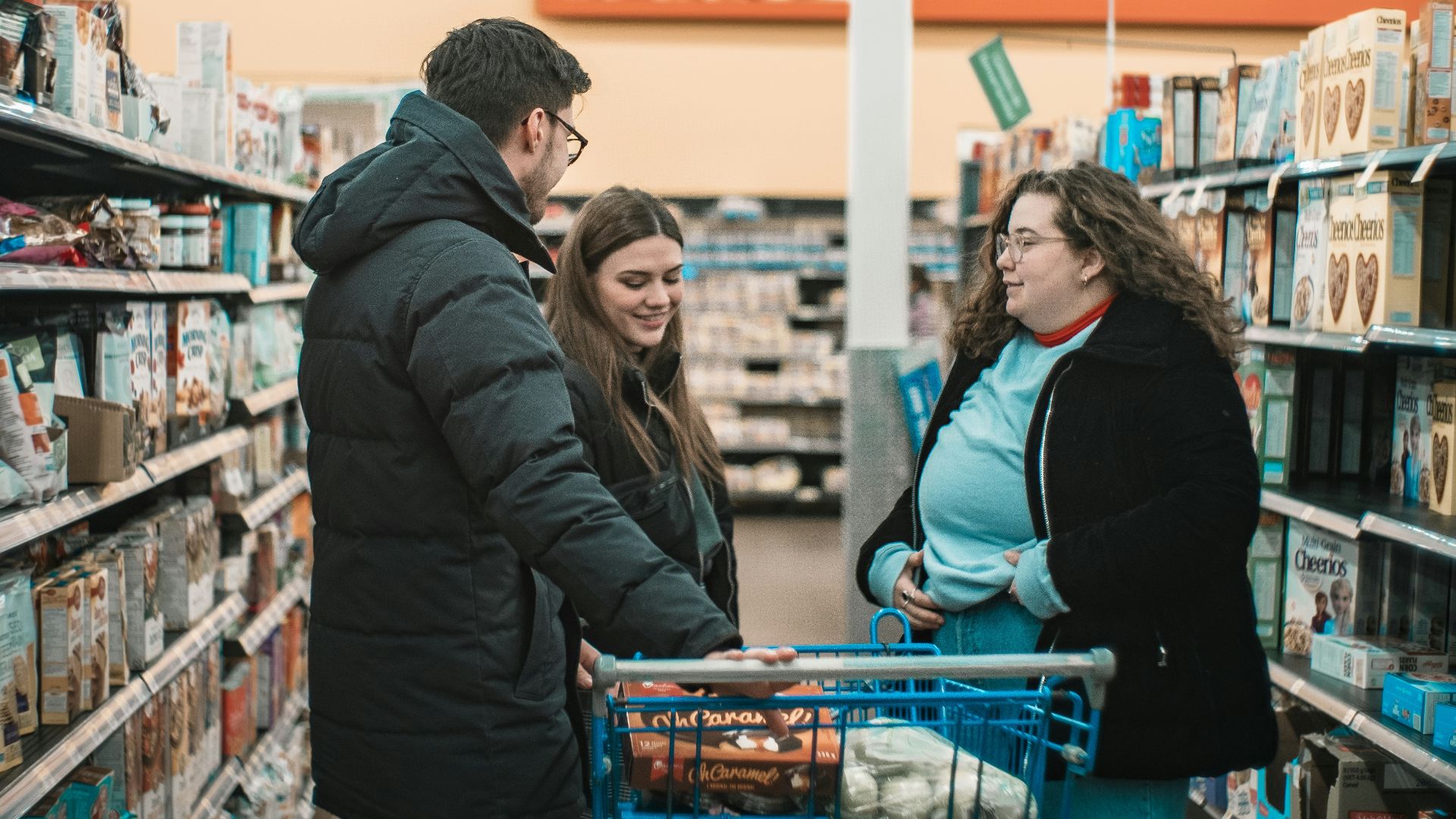 two men and man standing beside push cart
