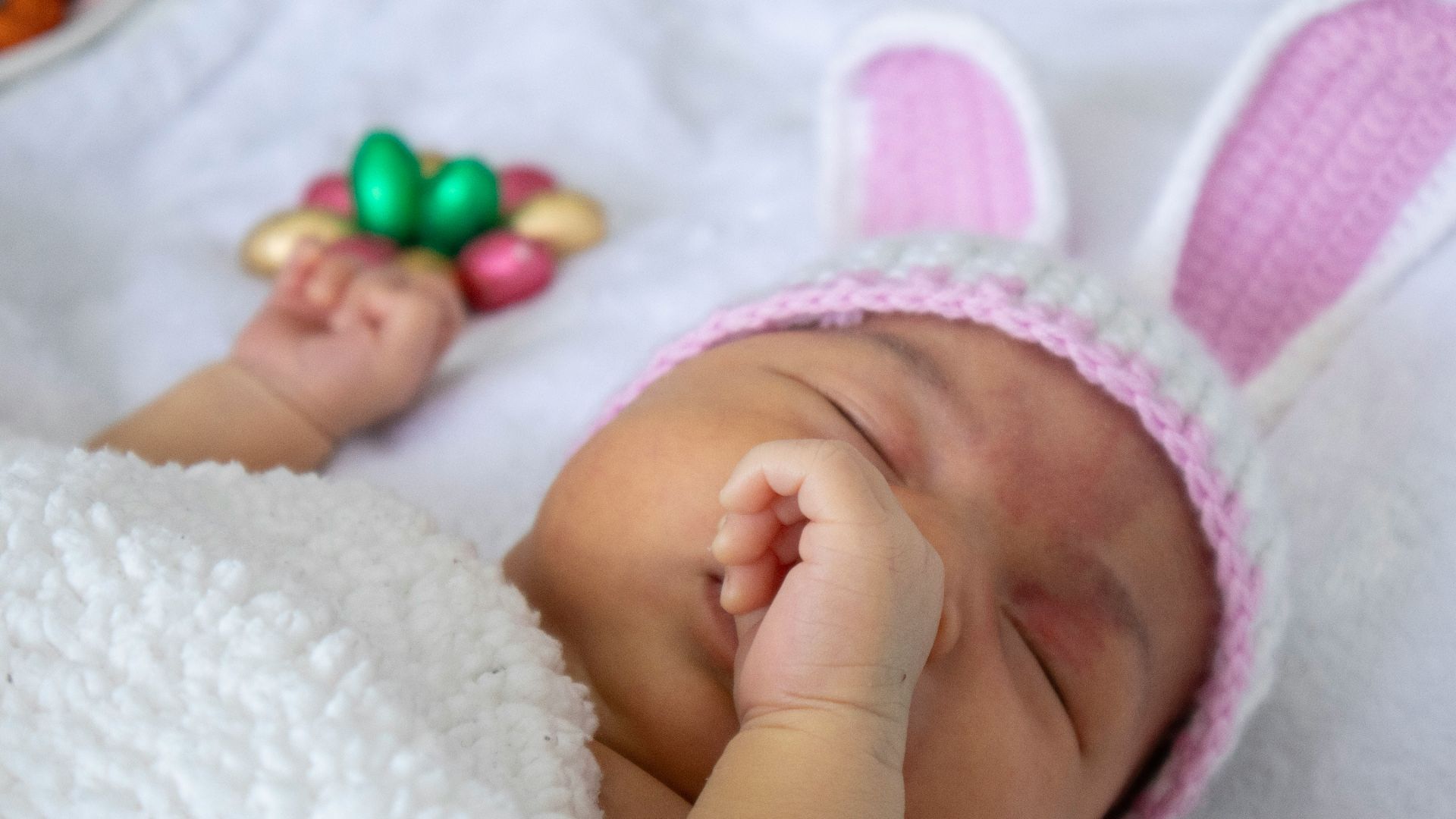 baby in pink knit cap