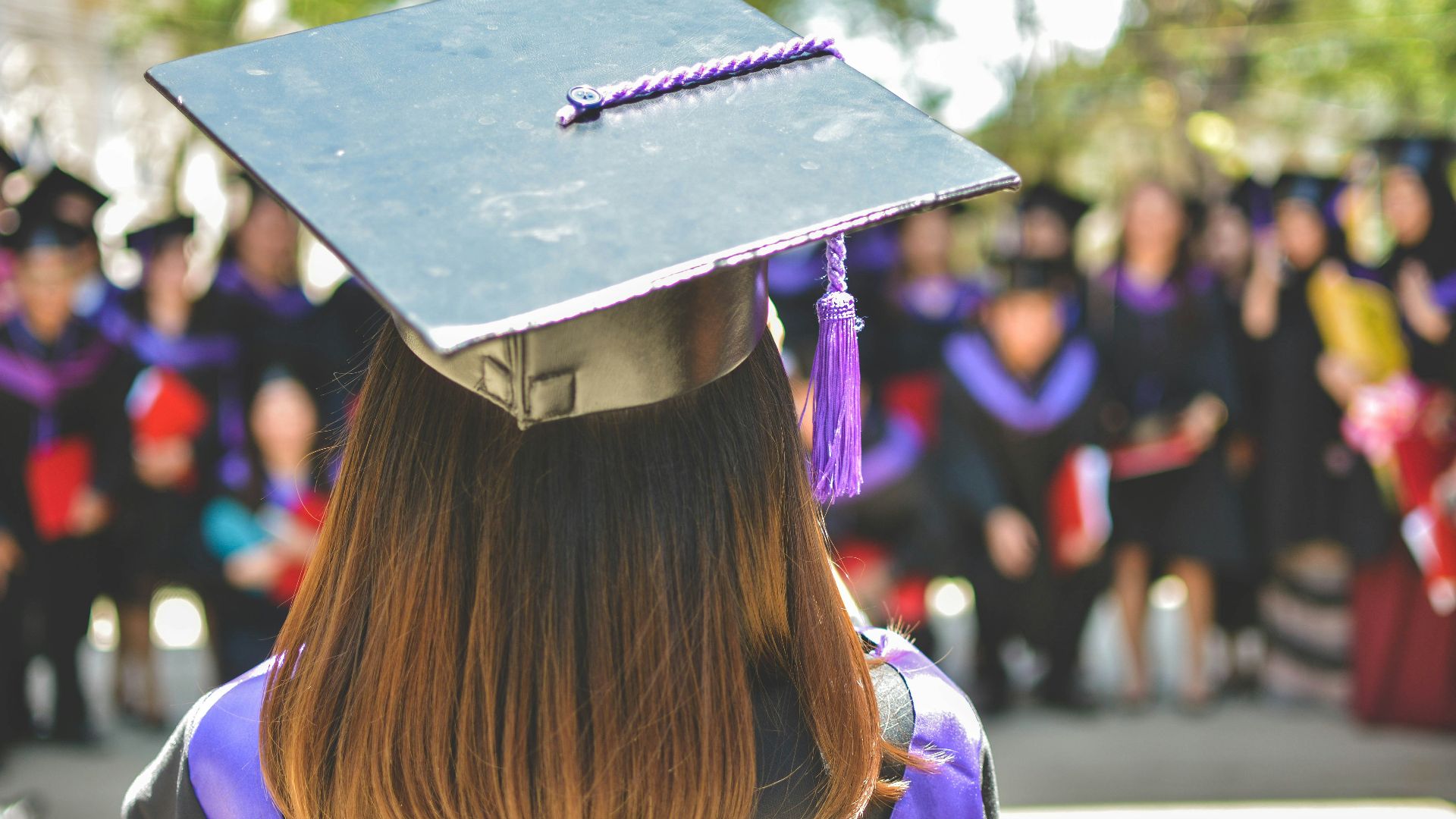 woman wearing academic cap and dress selective focus photography